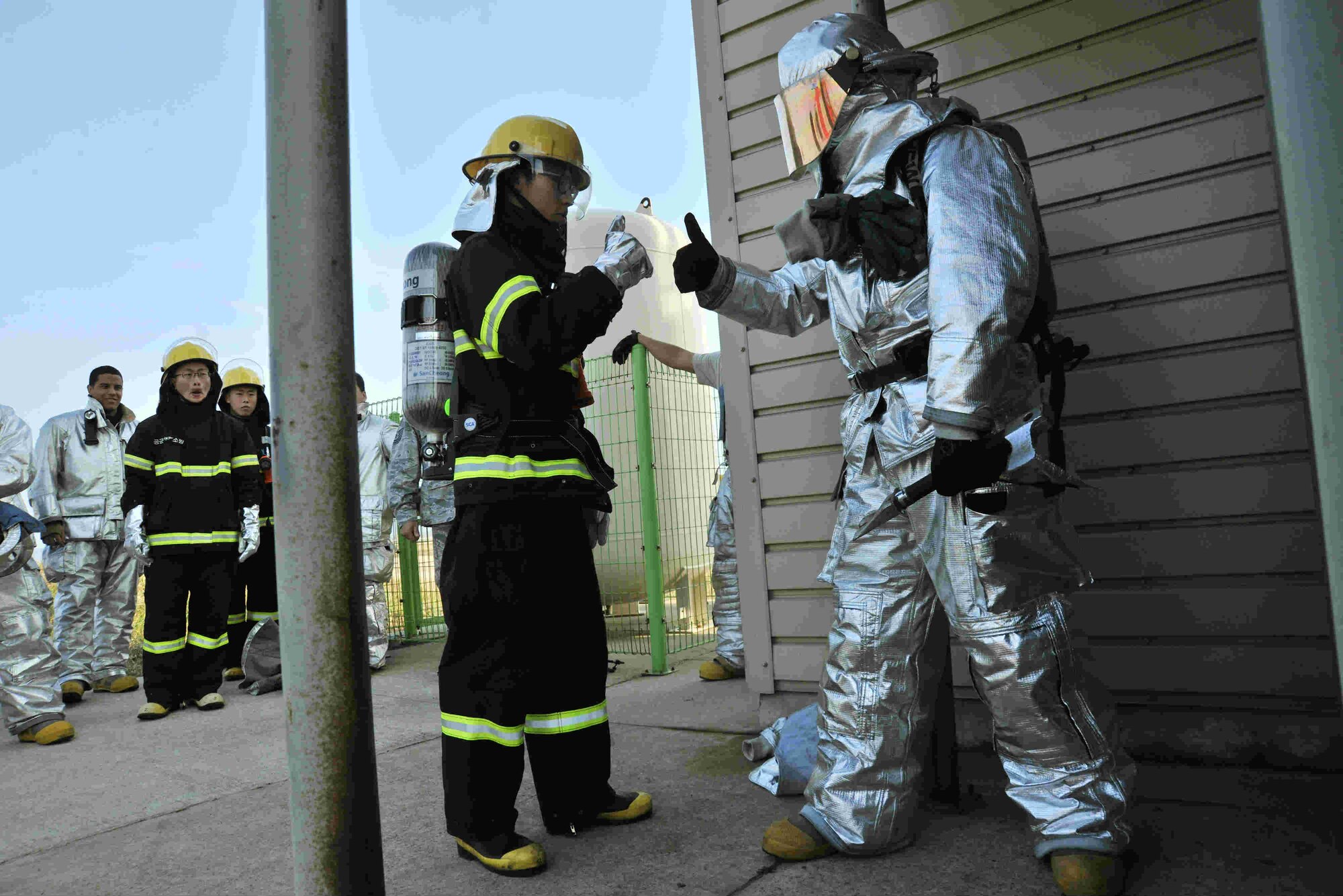 Staff Sgt. Jonathan Campos, 8th Civil Engineer Squadron firefighter, and a Republic of Korea Air Force firefighter from the 38th Fighter Group give each other “thumbs up” during joint search and rescue training at Kunsan Air Base, Republic of Korea, Nov. 28, 2011. Joint search and rescue training is held bi-annually; it strengthens the bond between USAF and ROKAF firefighters, while helping Kunsan’s firefighters stay sharp. (U.S. Air Force photo by Senior Airman Brittany Y. Auld/Released)