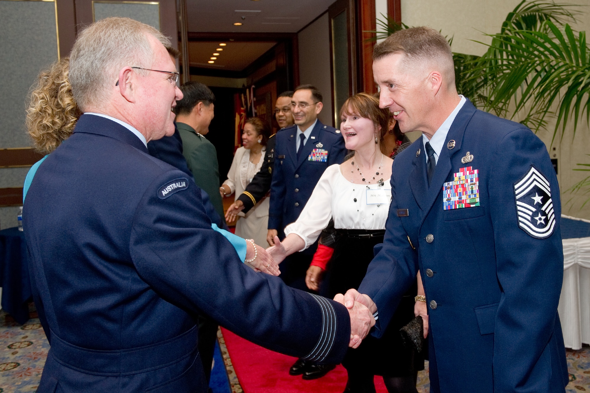 TOKYO, Japan -- (from left to right) Group Captain Anthony McCormack, United Nations Command (Rear) commander, greets Command Chief Master Sgt. Douglas McIntyre, U.S. Forces, Japan, and 5th Air Force command chief, during the United Nations Command 66th Annual Reception, Nov. 29, 2011 at New Sanno Hotel. (U.S. Air Force photo/Osakabe Yasuo)