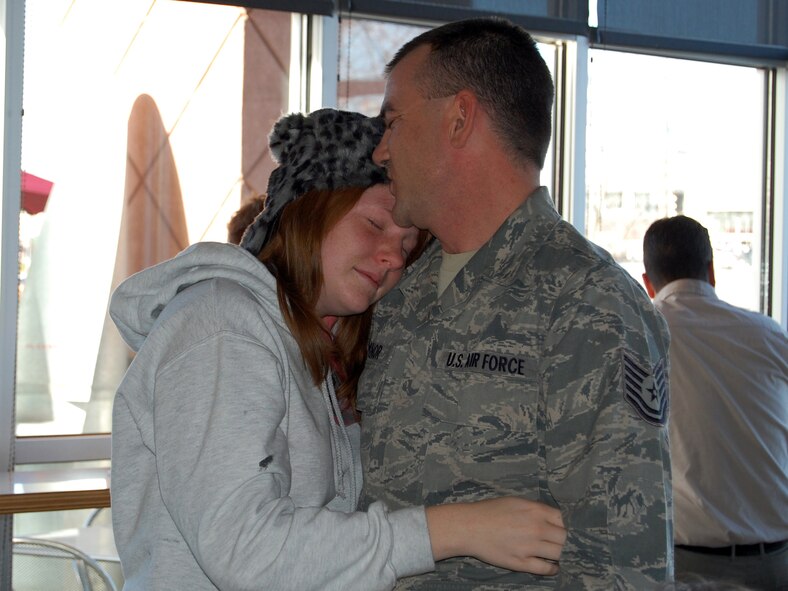 OMAHA, Neb. -- Tech. Sgt. Chuck Minor, 2d Systems Operations Squadron, hugs his daughter, Sarah, at a local restaurant on Nov. 29, after returning home early from a year-long deployment to Iraq. Minor is the Air Force Weather Agency’s information technology procurement manager. (Air Force photo by Ryan Hansen)