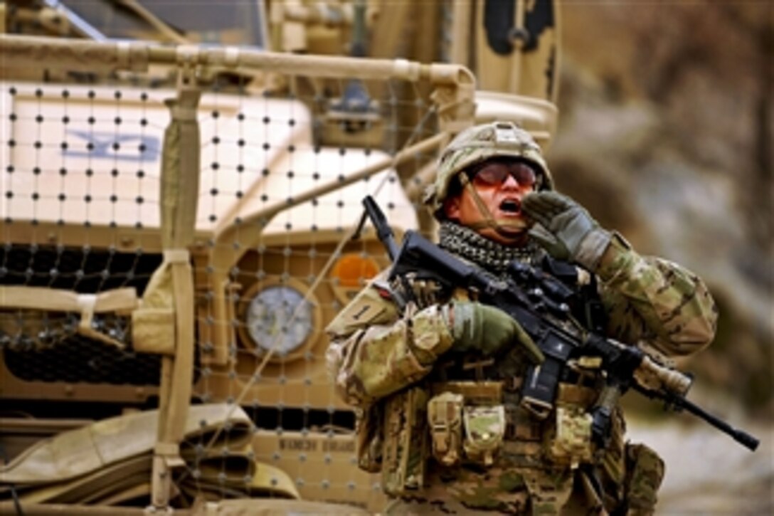 U.S. Army Staff Sgt. Mark Lynas calls for a member of his team during a mission in Shah Joy, Afghanistan, on Nov. 26, 2011.  Lynas, a squad leader assigned to Provincial Reconstruction Team Zabul, is deployed from Company C, 182nd Infantry Regiment, Massachusetts National Guard.  
