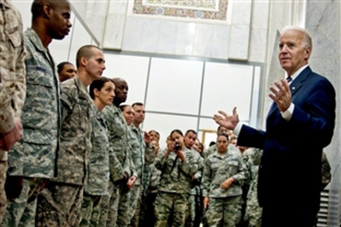 U.S. Vice President Joe Biden takes time to talk to more than a hundred airmen and soldiers after the Iraqi government's Day of Commitment ceremony in the Al Faw Palace on Victory Base Complex in Baghdad, Dec. 1, 2011. The ceremony commemorated the sacrifices and accomplishments of U.S. and Iraqi service members. Biden shook hands, took pictures and gave each service member a coin.