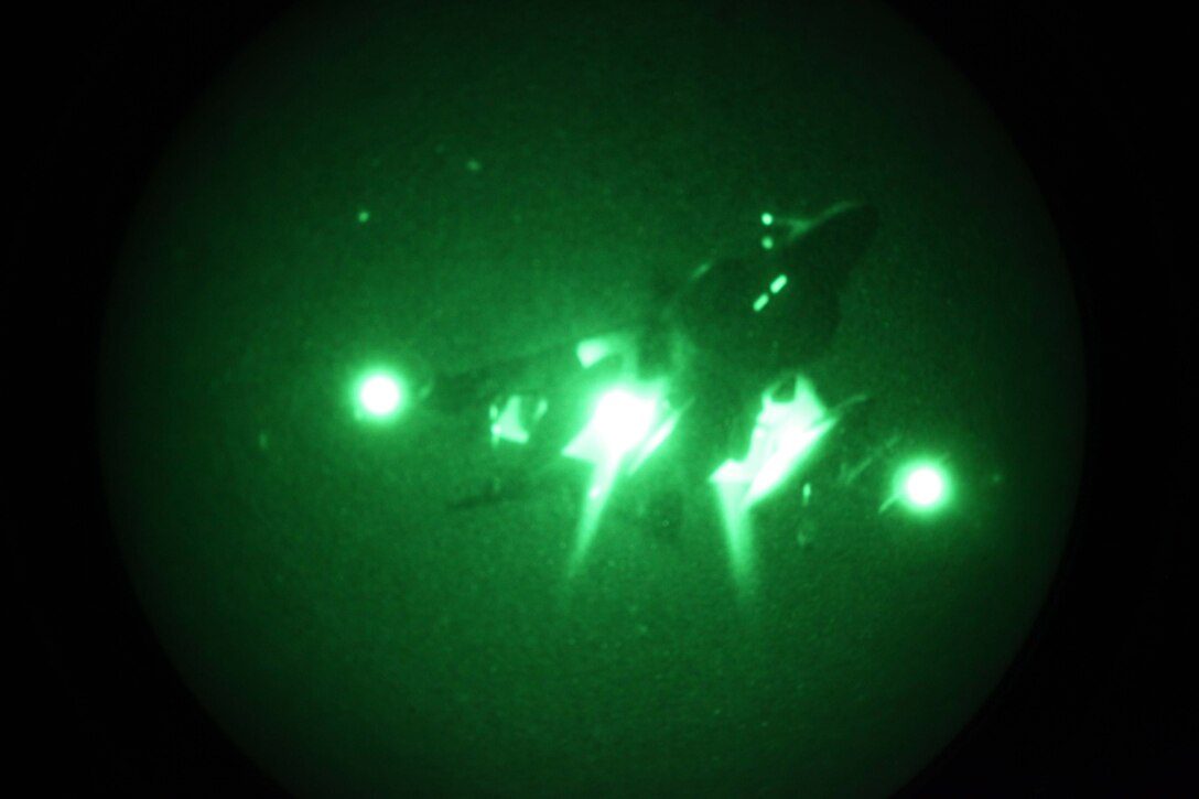 An AV-8B Harrier from 24th Marine Expeditionary Unit, commences a vertical landing at night aboard the USS Iwo Jima (LHD 7) off the coast of Camp Lejeune, N.C., Dec. 1, 2011. The 24th Marine Expeditionary Unit is currently taking part in Composite Training Unit Exercise (COMPTUEX), scheduled to take place Nov. 28 to Dec. 21. The training is meant to develop cohesion between the 24th MEU and Amphibious Squadron 8 (PHIBRON-8) in conducting amphibious operations, crisis response, and limited contingency operations while operating from the sea. The AV-8B Harriers are a detachment from VMA-542 based at Marine Corps Air Station Cherry Point, N.C., and comprise part of Marine Medium Tiltrotor Squadron VMM-261 (Reinforced), which is the Aviation Combat Element for the 24th MEU.