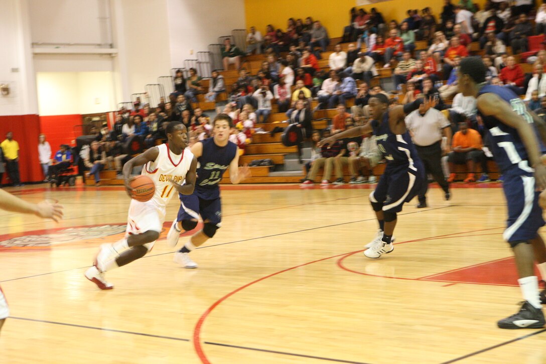 Craig Wilson, power forward with the Lejeune High School Devil Pups men’s varsity basketball team, drives in the ball in during the game against the Sprink Creek Gators, in the gymnasium at LHS aboard Marine Corps Base Camp Lejeune, Dec. 2. The Devil Pups outscored the Gators 75-73 in the last seconds of the game, continuing their undefeated season.