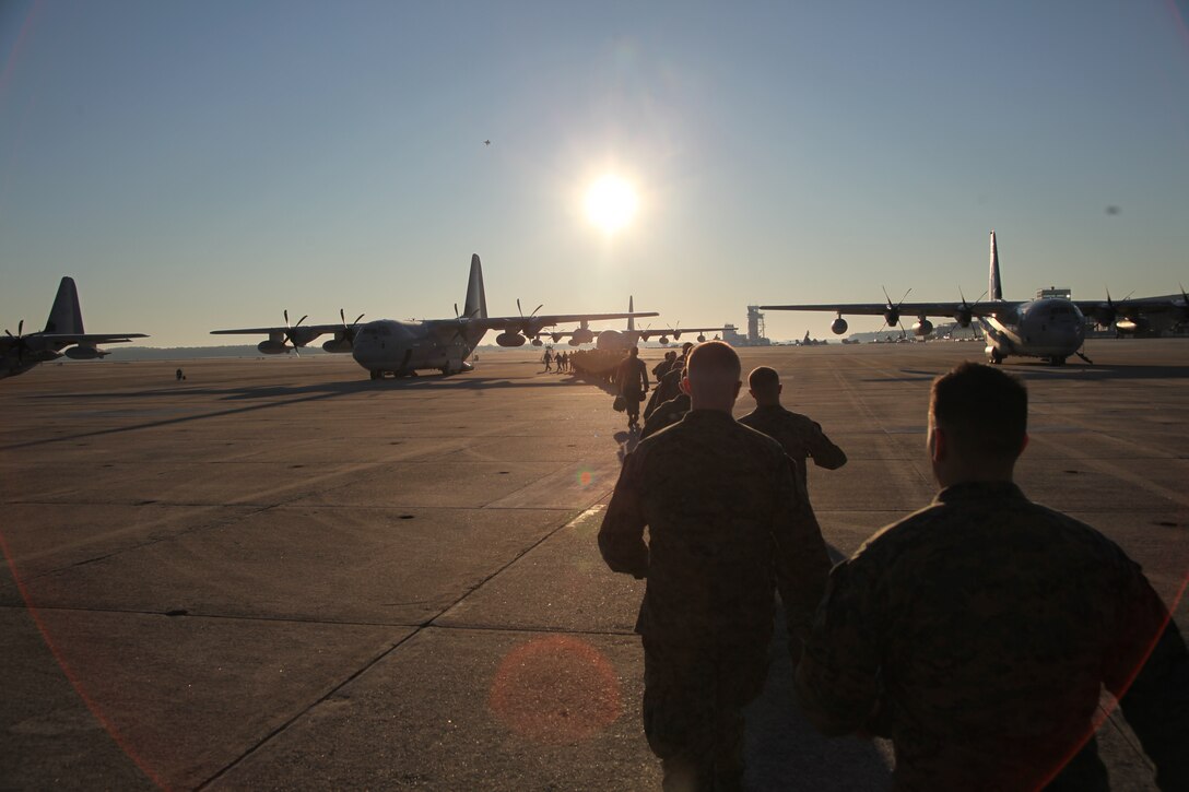 Marines with 2nd Low Altitude Air Defense Battalion cross the flight lineto their KC-130J Hercules beginning their trip to Quantico, Va., to visit the National Museum of the United States Marine Corps Dec. 2.