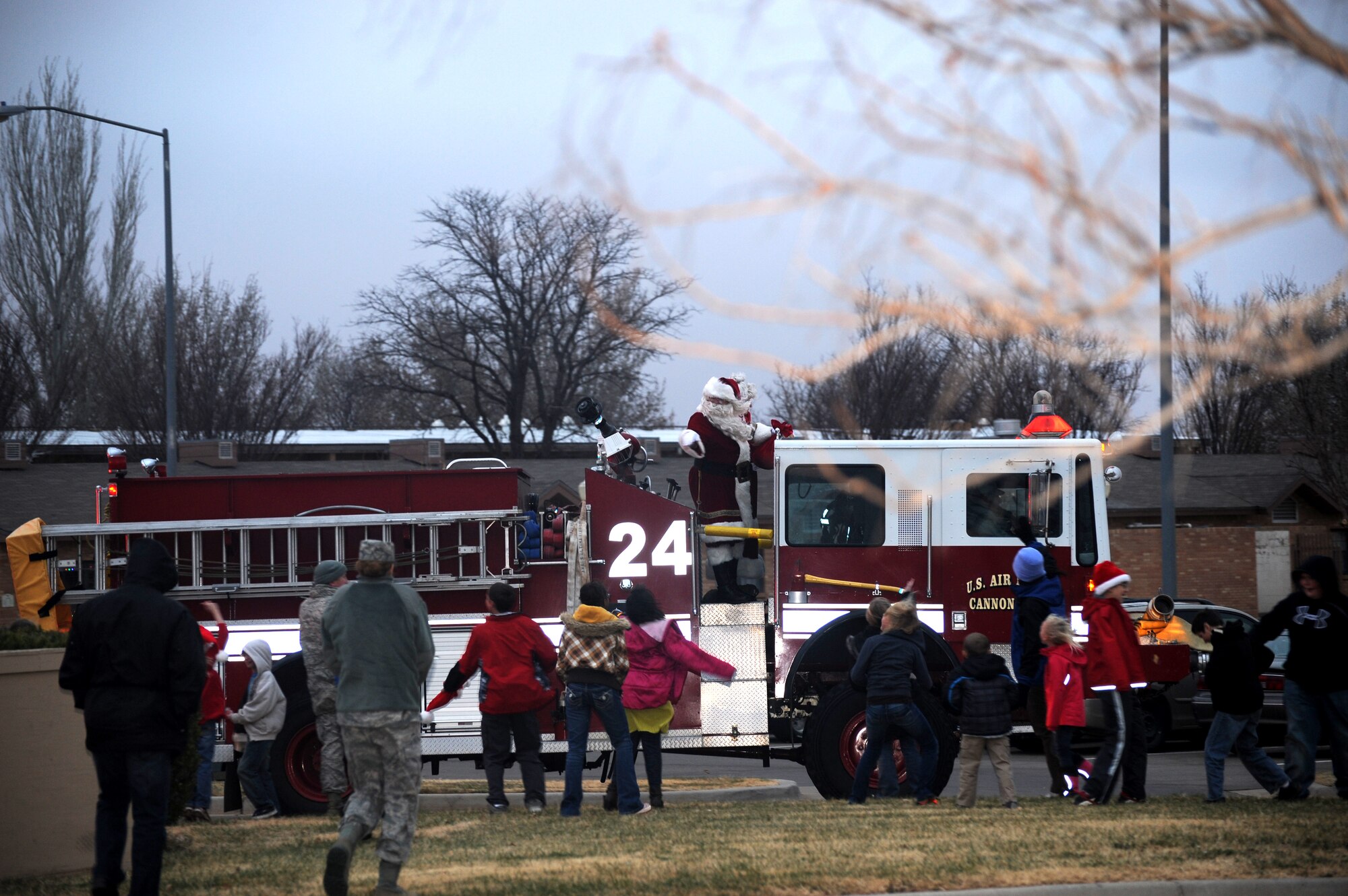 Cannon kids wave to Santa Claus during the holiday parade at Cannon Air Force Base, N.M., Dec. 1, 2011. More than 250 people from Cannon and the surrounding communities enjoyed the parade despite temperatures of 30 degrees and strong winds . (U.S. Air Force photo by Airman1st Class Xavier Lockley)