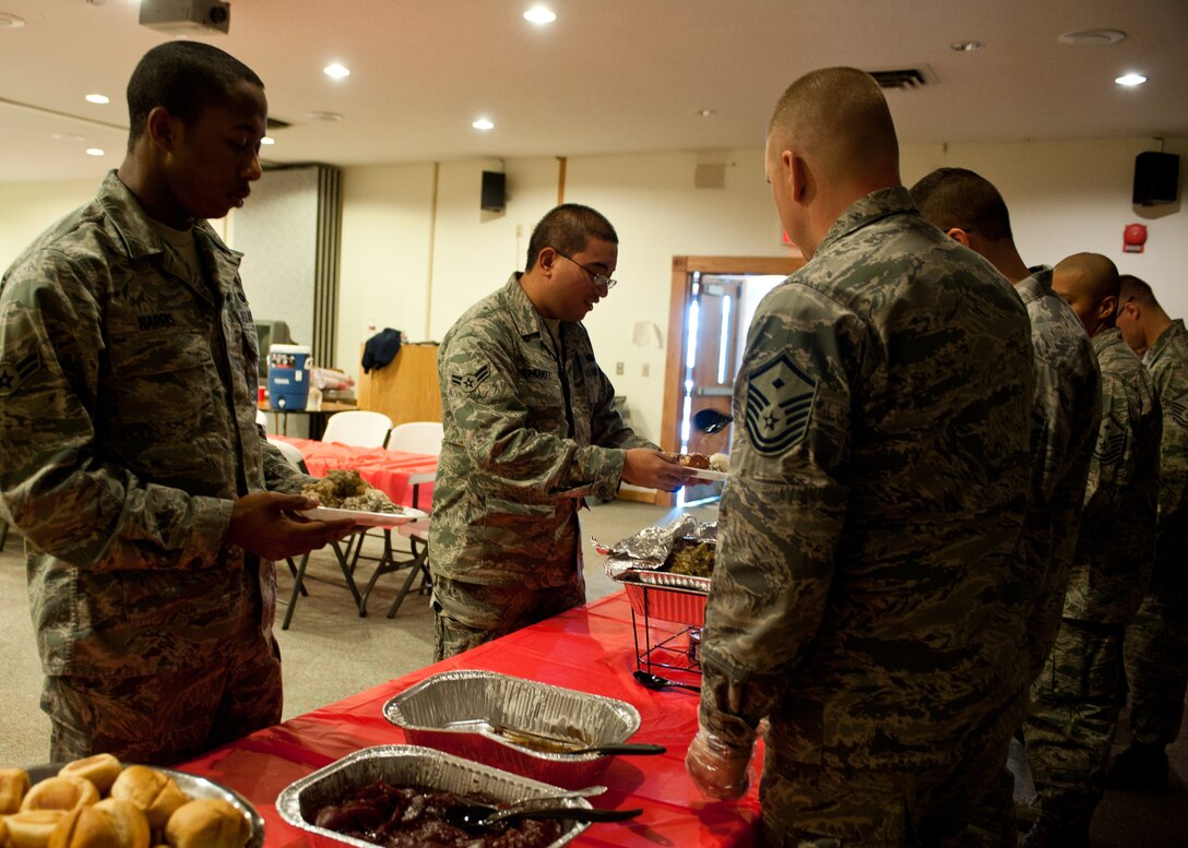 Airmen line up to get a home cooked meal prepared and provided by the Ellsworth Enlisted Spouses Club and first sergeants at the Chapel Activity Center on Ellsworth Air Force Base, S.D., Nov. 21, 2011. Dormitory residents had the opportunity to have a home cooked Thanksgiving meal as part of the holiday season. (U.S. Air Force photo by Airman Alystria Maurer/Released)