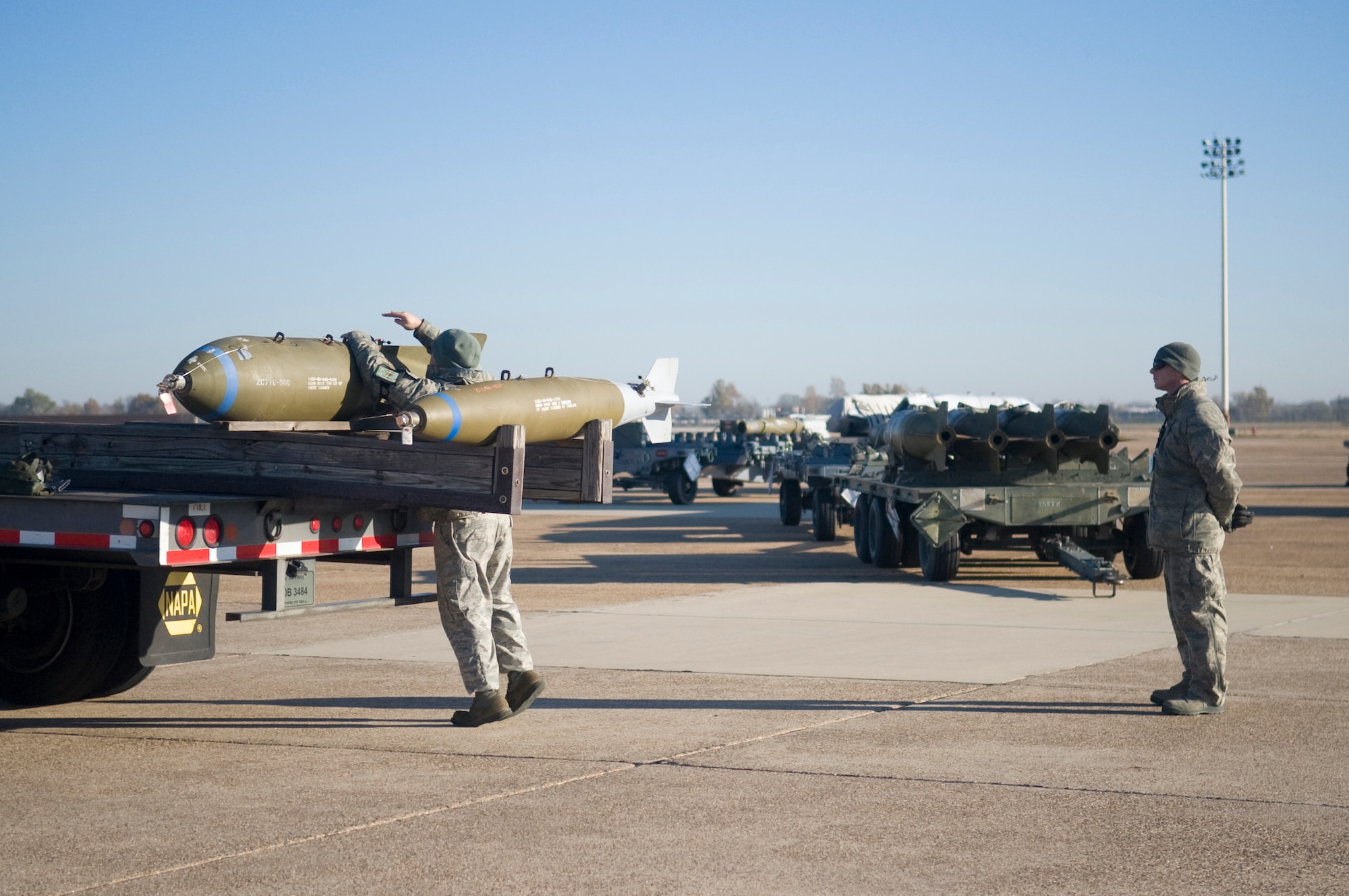Staff Sgt. Jason Wright, 2nd Maintenance Operations Squadron, inspects an M117 bomb to be loaded onto a B-52H Stratofortress as Tech. Sgt. James Pavatt, 2 MOS, evaluates his performance. Weapon loaders are tested monthly on proficiency and accuracy to ensure mission readiness. (U.S. Air Force photo/Senior Airman Kristin High)(RELEASED) 