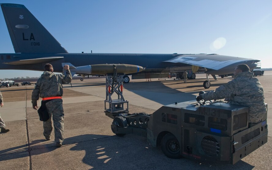 Staff Sgt. Bryan Tune, 2nd Maintenance Operations Squadron, assists Tech. Sgt. Marlon George, 2 MOS, as he drives a MJ1 bomb lift truck to load a Mark 82 bomb on a B-52H Stratofortress on Barksdale Air Force Base, La., Nov. 30. An MJ1 truck is used to transport weapons from the storage trailers to the aircraft. (U.S. Air Force photo/Senior Airman Kristin High)(RELEASED)