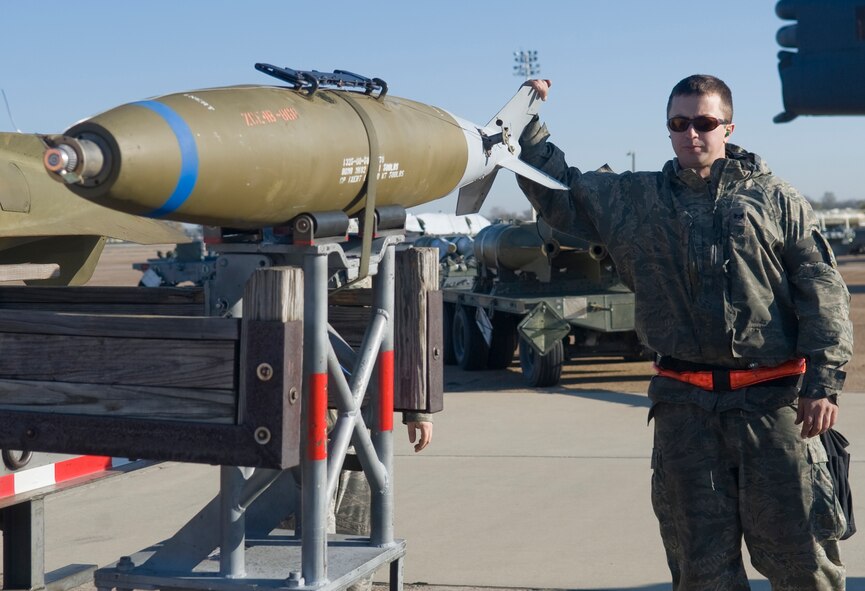 Staff Sgt. Bryan Tune, 2nd Maintenance Operations Squadron, holds onto a Mark 82 bomb on Barksdale Air Force Base, La., Nov. 30. The Mark 82 weighs 500 pounds and is one of the most commonly used air-dropped weapons in the world. (U.S. Air Force photo/Senior Airman Kristin High)(RELEASED)