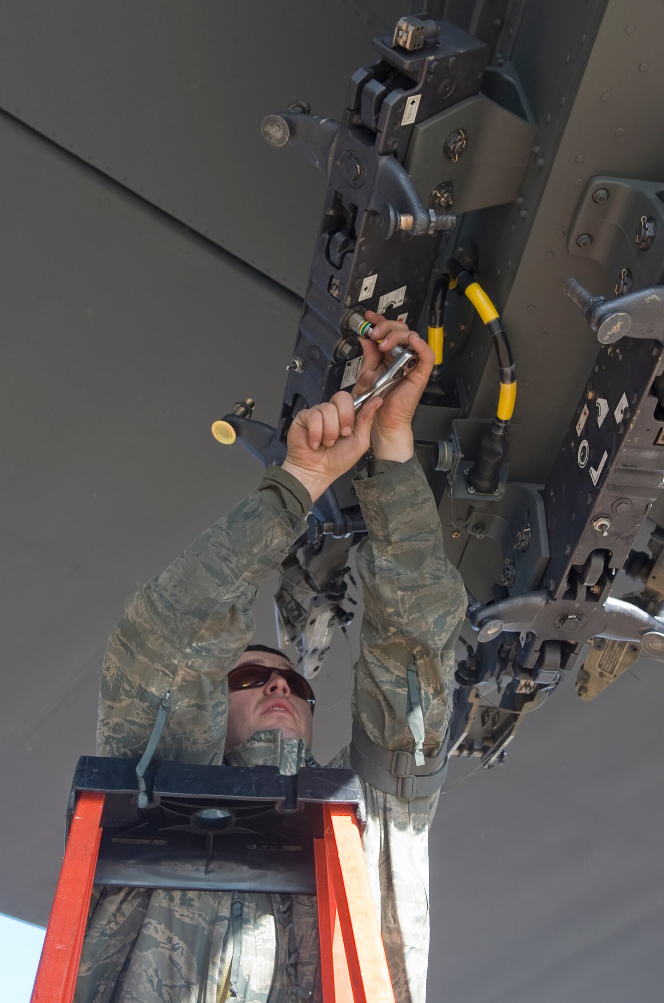 Staff Sgt. Bryan Tune, 2nd Maintenance Operations Squadron, prepares a heavy stores adaptor beam for a bomb to be loaded onto a B-52H Stratofortress on Barksdale Air Force Base, La., Nov. 30. Tune is part of a four-man loading team that prepares, transports and loads bombs on military aircraft.  (U.S. Air Force photo/ Senior Airman Kristin High)(RELEASED)