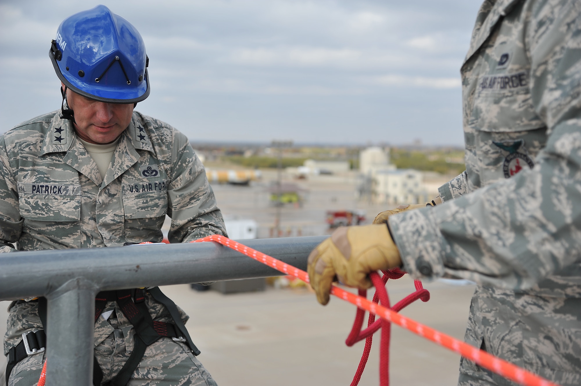 GOODFELLOW AIR FORCE BASE, Texas -- Maj. Gen. Leonard Patrick, 2nd Air Force Commander, prepares to repel down the side of a building at the Louis F. Garland Fire Academy here Dec. 1. This is one of the multiple places he stopped by during his three-day tour of Goodfellow Nov. 30-Dec. 2. (U.S Air Force photo/Airman 1st Class Michael Smith)
