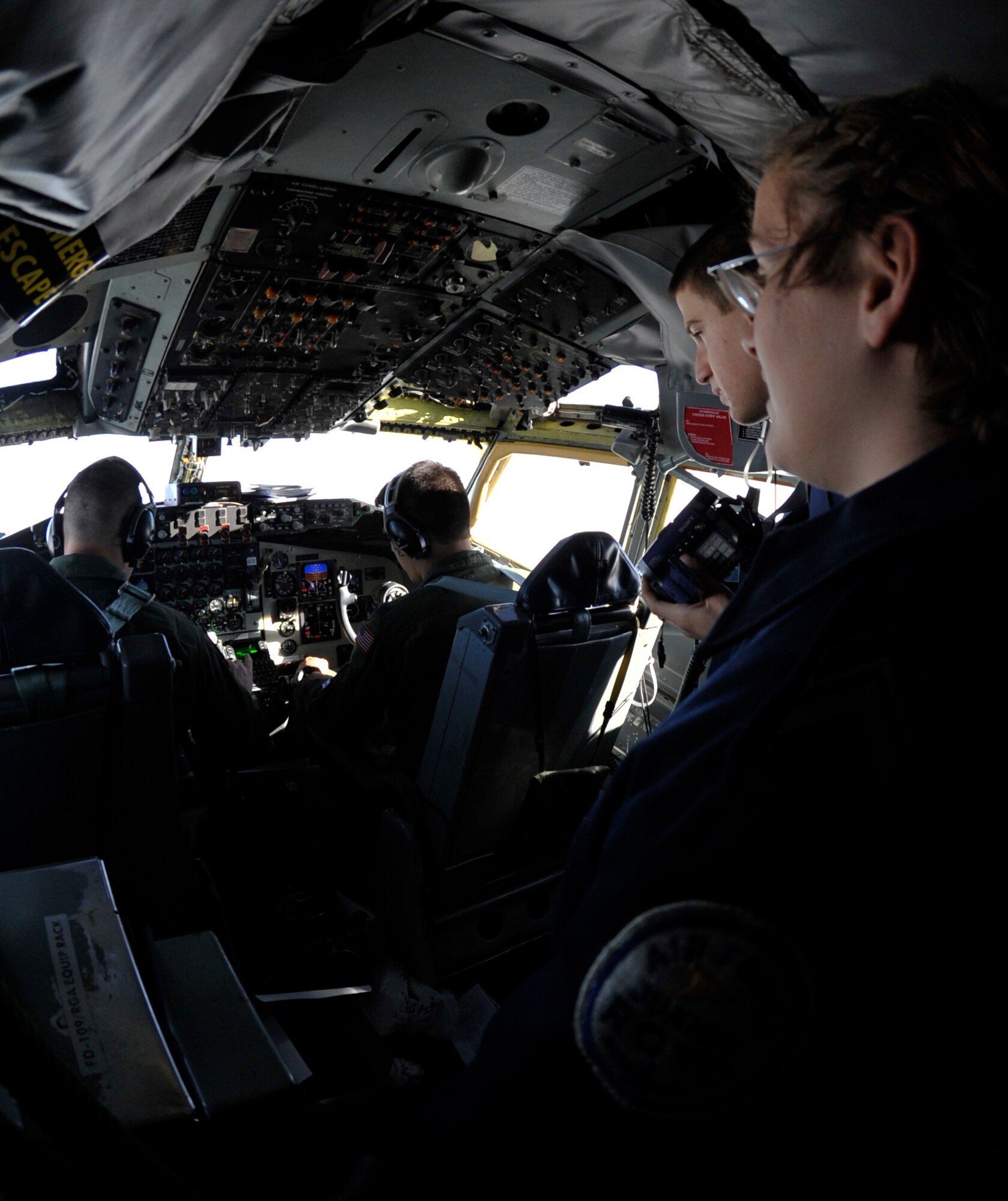 Cadet Lt. Col. Jolene O'Donnell and Cadet Airman Basic Zachary Morgan, Junior Reserve Officer Training Corps cadets from Derby High School, observe the cockpit of a KC-135 Stratotanker while in flight Dec. 1, 2011.   JROTC highs school programs introduce student to military customs and courtesies, citizenship in the United States, first aid, wellness, health and fitness, basic drill and ceremonies, effective communications, management, human relations and life in the U.S. military.  (U.S. Air Force photo/Senior Airman Abigail Klein)