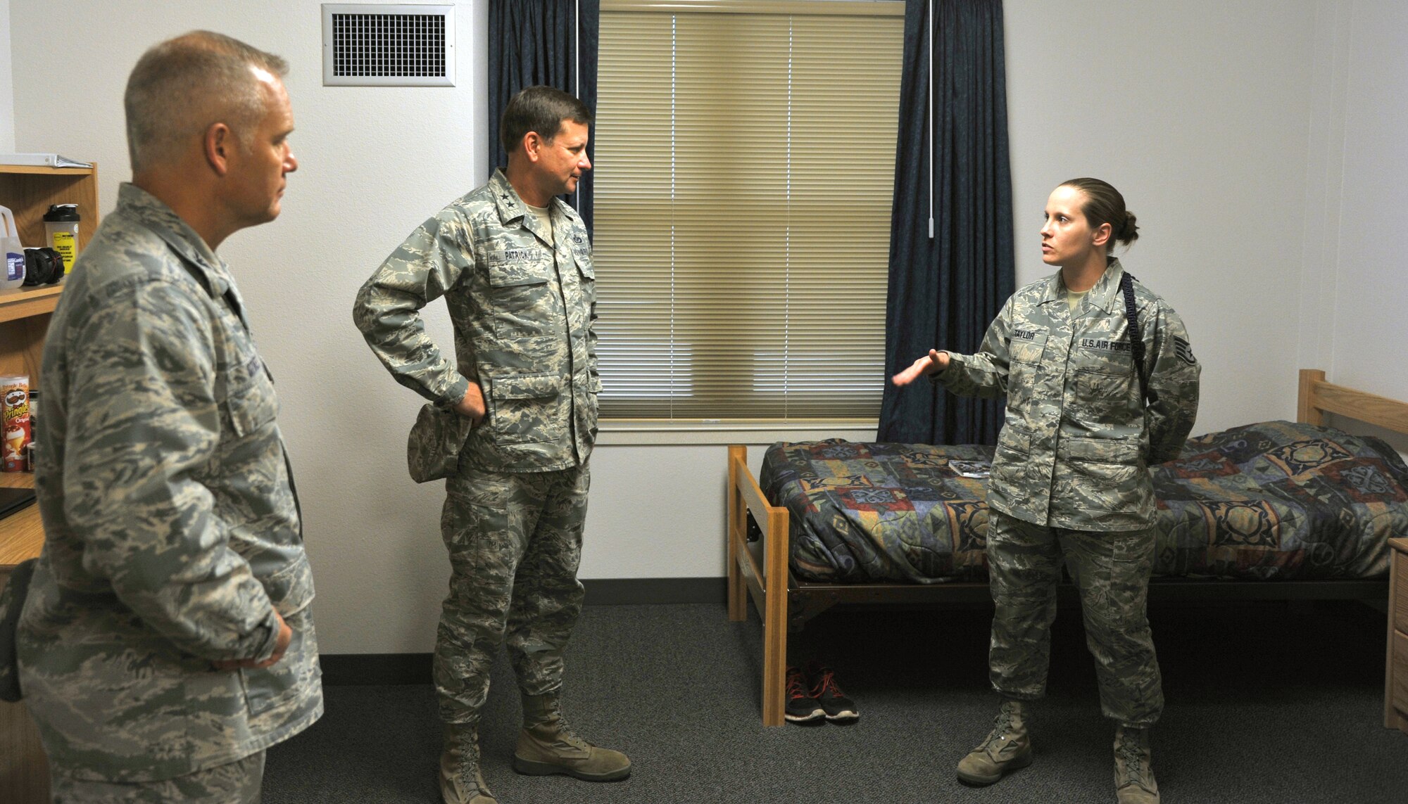 GOODFELLOW AIR FORCE BASE, Texas -- Maj. Gen. Leonard Patrick, 2nd Air Force Commander, and Col. John Stokes, 2nd AF Mobilization Assistant to the Commander, are shown one of the new dorm rooms Dec. 1 by Staff. Sgt Amie Taylor, 315th Training Squadron Military Training Leader. The newly built dorm buildings are another addition to Goodfellow that are new to General Patrick since his last visit here five years ago. (U.S Air Force photo/Airman 1st Class Michael Smith)