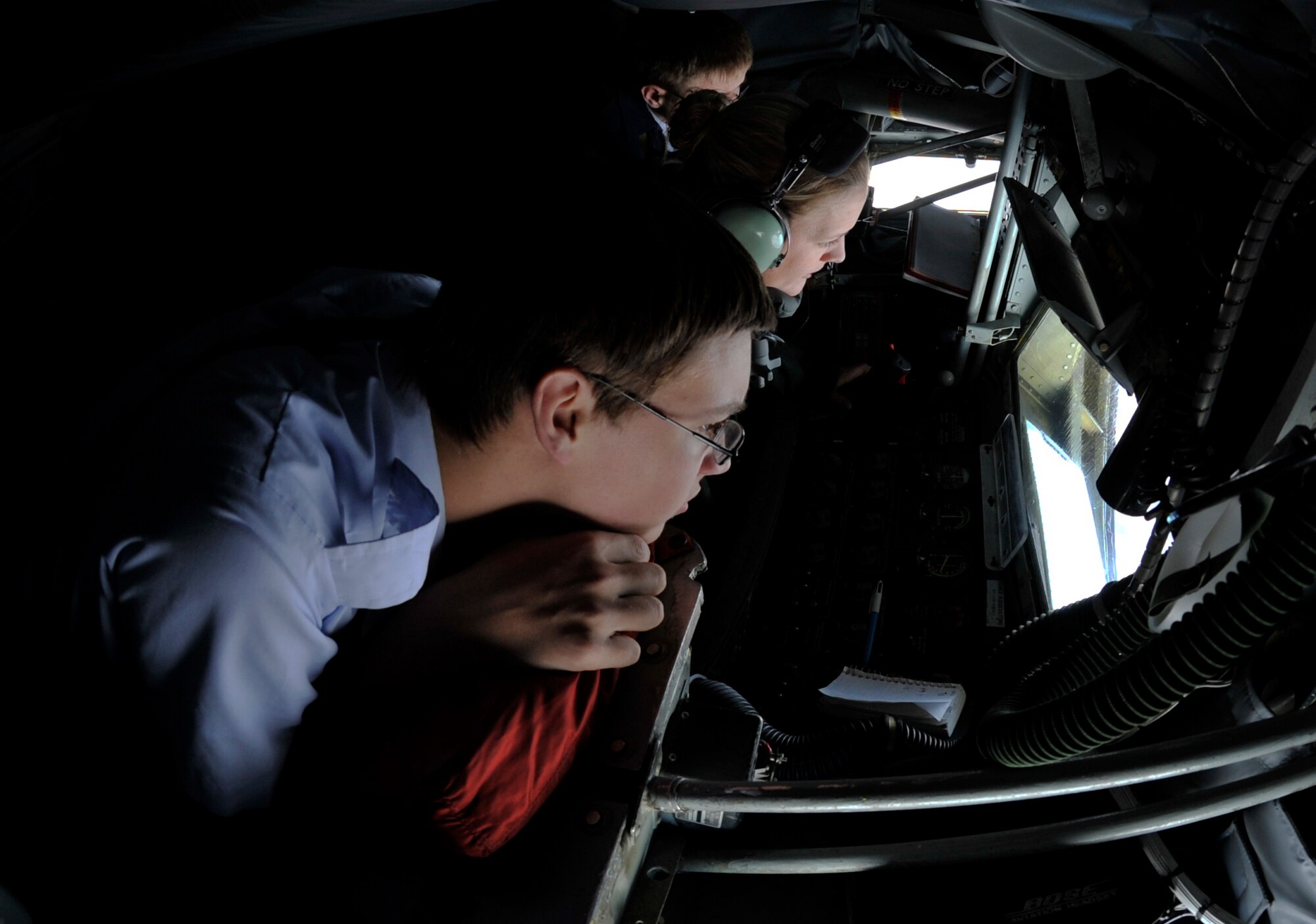 Cadet Airman Basic Michael Schartz, a Junior Reserve Officer Training Corps cadet from Derby High School, watches as Staff Sgt. Killian Lange, 350th ARS boom operator, refuels a B-1B Lancer from Dyess Air Force Base, Texas, Dec. 1, 2011.  Thirty-eight cadets visited McConnell to witness McConnell's refueling mission and gain further knowledge about the Air Force way of life.  (U.S. Air Force photo/Senior Airman Abigail Klein)