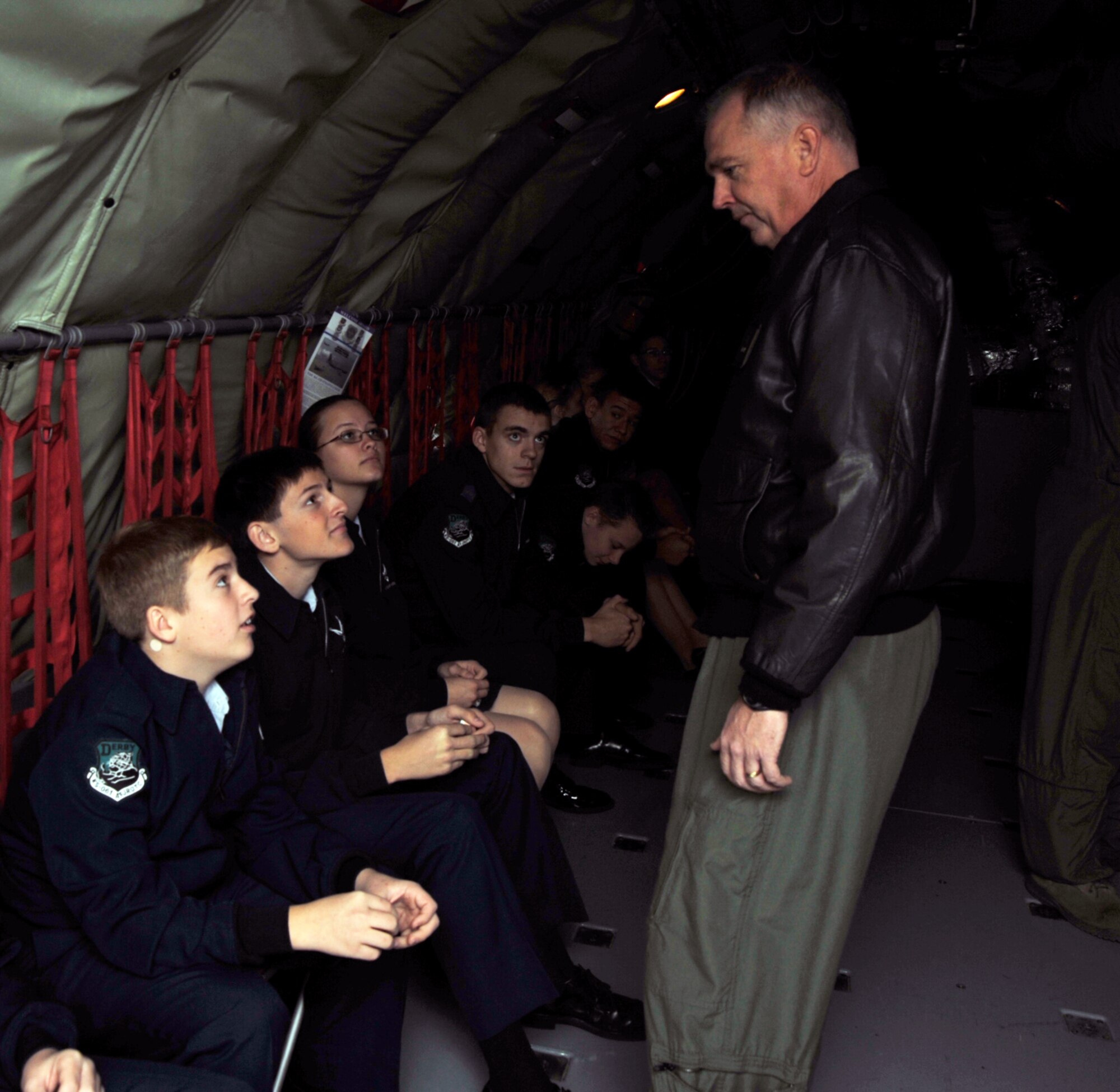 Col. Ricky Rupp, 22nd Air Refueling Wing commander, greets Junior Reserve Officer Training Corps cadets from Derby High School before they take off in a KC-135 Stratotanker Dec. 1, 2011, McConnell Air Force Base.  Thirty-eight cadets observed McConnell's air refueling mission firsthand.  (U.S. Air Force photo/Senior Airman Abigail Klein)