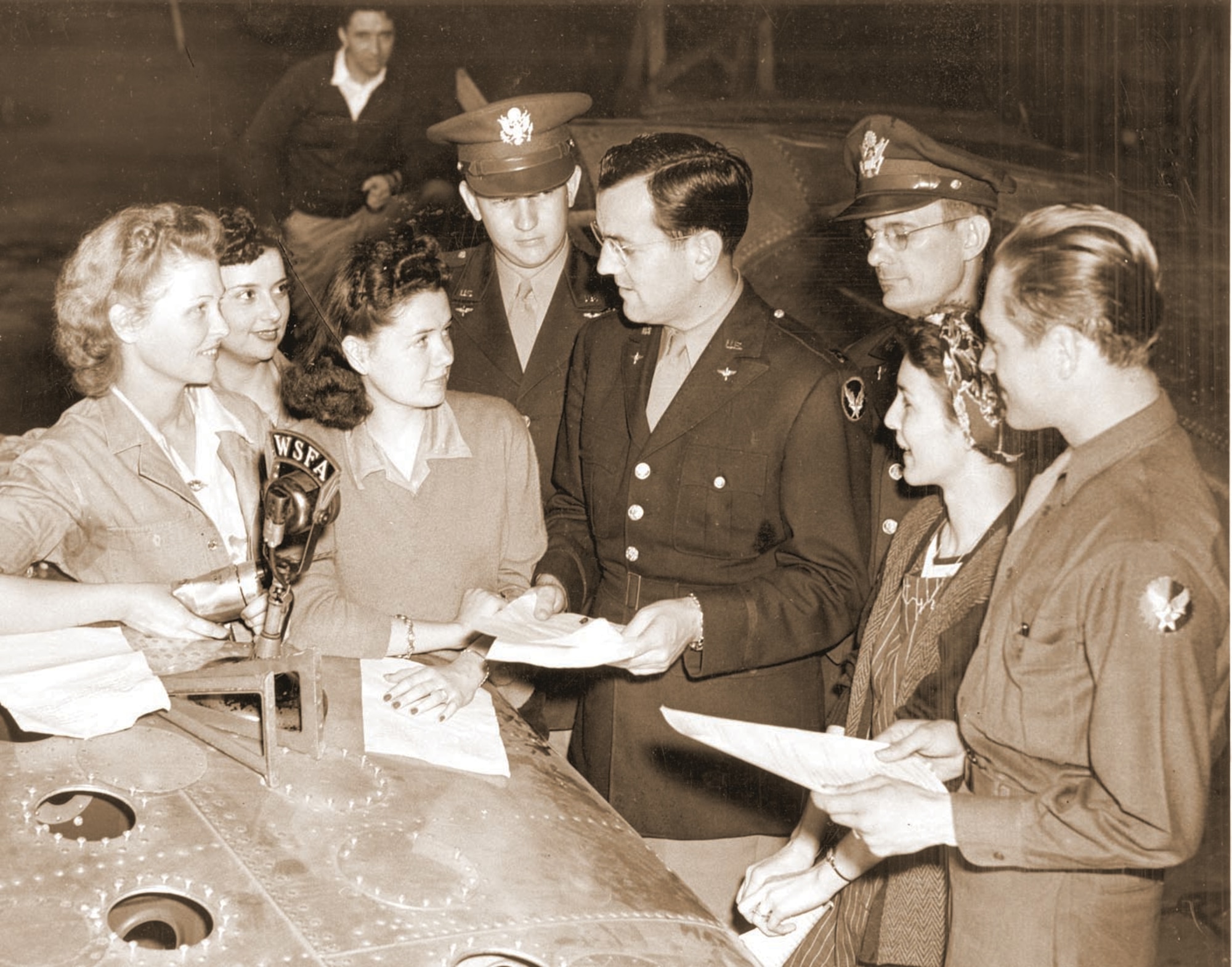 In this Air University History office file photo, Glenn Miller, center, prepares for one of the more than 500 radio broadcasts in which he and his band performed as part of morale-boosting efforts in tihe Army Air Force.  