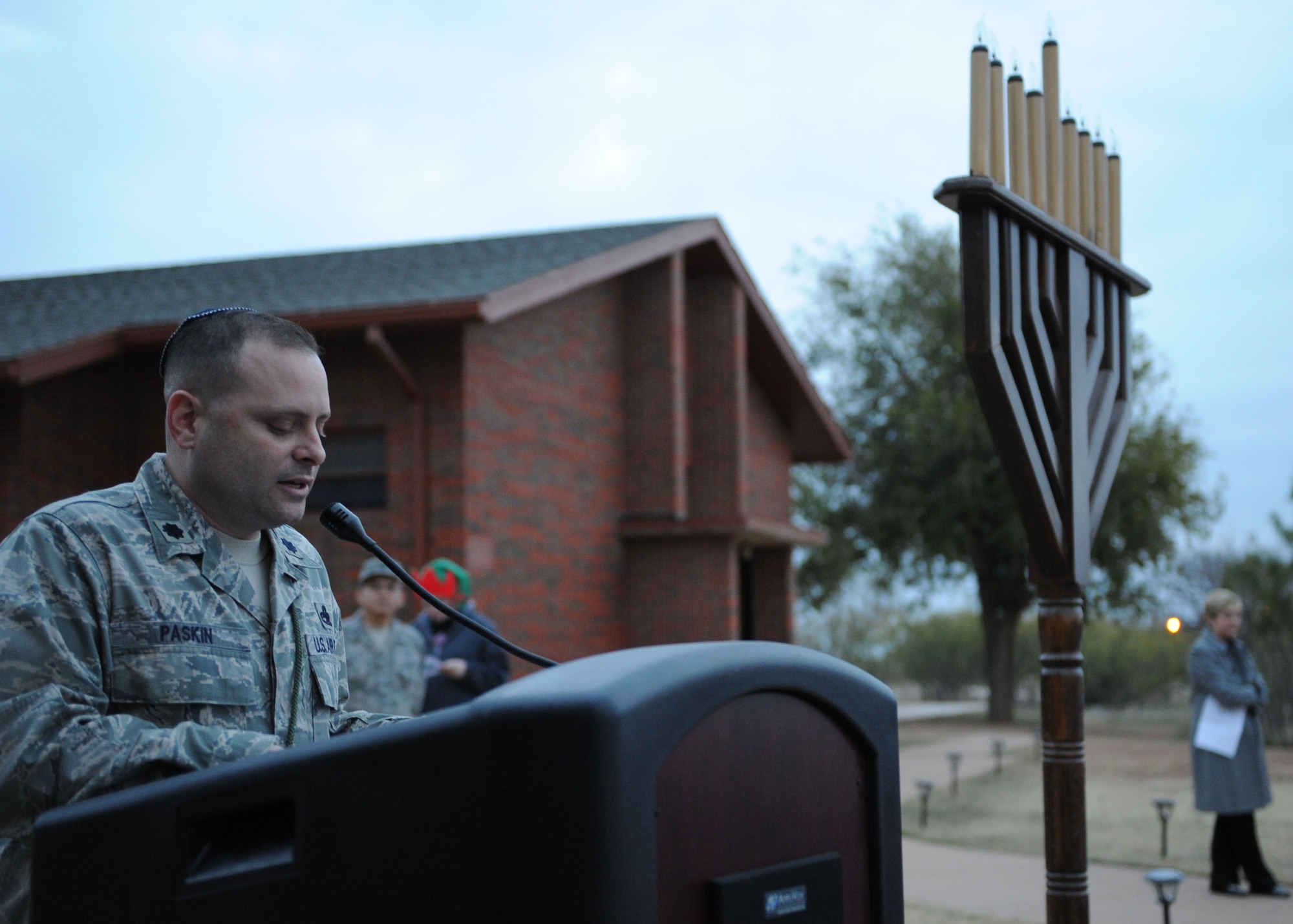 Lt. Col. Matthew Paskin, 7th Aircraft Maintenance Squadron commander, talks about the history of Hanukkah during a Christmas tree and Menorah lighting Dec. 1, 2011, at Dyess Air Force Base, Texas. Dyess members gathered for carols, fellowship and holiday refreshments to celebrate the holiday season. (U.S. Air Force photo by Airman 1st Class Jonathan Stefanko/ Released)