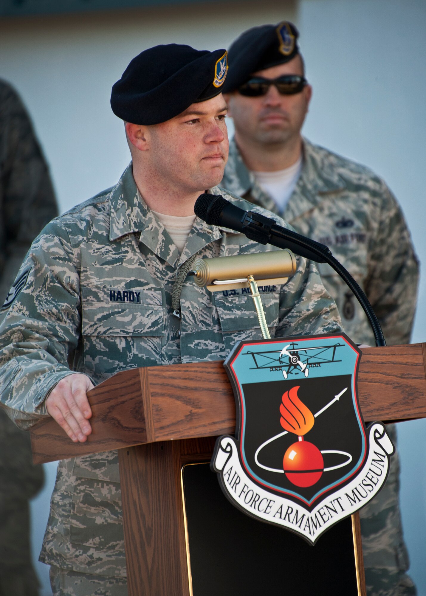 Staff Sgt. Brandon Hardy, of the 96th Security Forces Squadron, speaks at the memorial ceremony about his military working dog, IQ, at the Air Force Armament Museum, Dec. 1.  IQ died unexpectedly Nov. 6 of bloat, a stomach condition.  He joined the Air Force in March 2010 and came to Eglin in Nov.  2010.  He was fully trained and qualified by Hardy in May.  At the memorial, Hardy said IQ’s name fit him perfectly and he served his country well.  (U.S. Air Force photo/Samuel King Jr.)