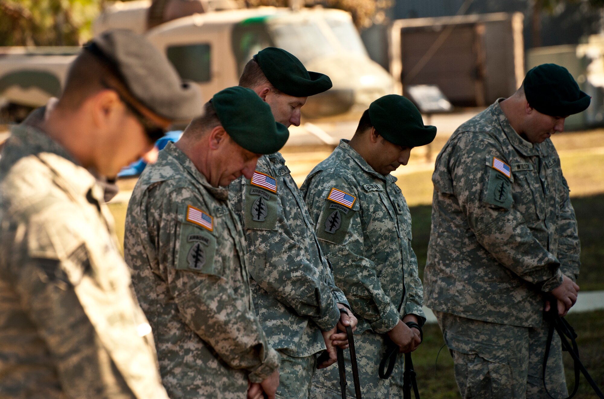 Air Force and Army dog handlers bow their heads during the military working dog memorial ceremony held for IQ, one of Eglin’s K-9s, at the Air Force Armament Museum, Dec. 1.  IQ died unexpectedly Nov. 6 of bloat, a stomach condition.  He joined the Air Force in March 2010 and came to Eglin in Nov.  2010.  He was fully trained and qualified by his partner, Staff Sgt. Brandon Hardy, of the 96th Security Forces Squadron, in May.  At the memorial, Hardy said IQ’s name fit him perfectly and he served his country well.  (U.S. Air Force photo/Samuel King Jr.)