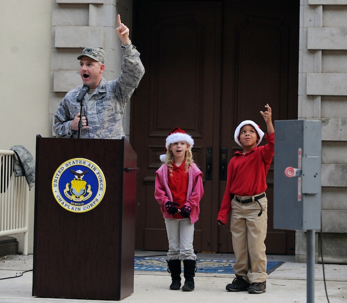 Col. Tim Fay, 2nd Bomb Wing commander, counts down with Elizabeth Maxwell, 6, and Darrean Harris, 6, to kick off the holiday tree lighting ceremony on Barksdale Air Force Base, La., Dec. 1. After the countdown a fire truck dropped Santa Claus off at the event. (U.S. Air Force photo/Airman 1st Class Micaiah Anthony)(RELEASED)