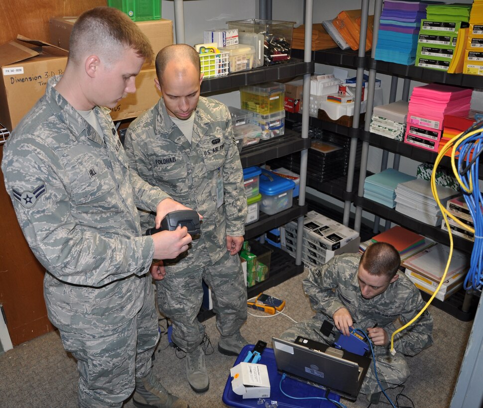 Airmen 1st Class Kyle Hill, Senior Airman Christopher Rushing and Airman 1st Class Andrew Foldhazi work together to get the STARBASE Maxwell wireless connection established recently.  All three Airmen volunteered their time and talents to help with the project, which will impact the educational enrichment of thousands of local children. 