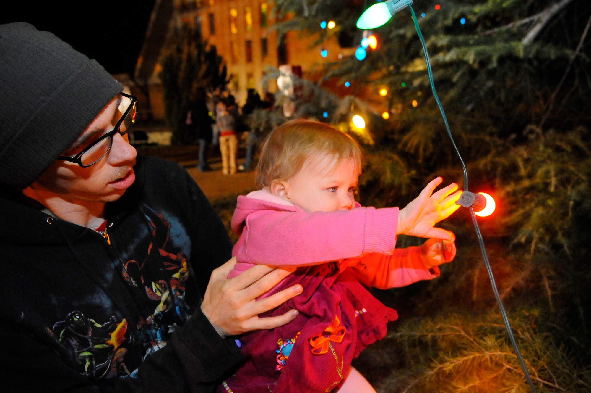 Penny Lane, 16 month-old daughter of A1C Nicholas Lane and wife Caitlin, checks out the lights on Robins Chapel Christmas tree. U. S. Air Force photo by Sue Sapp