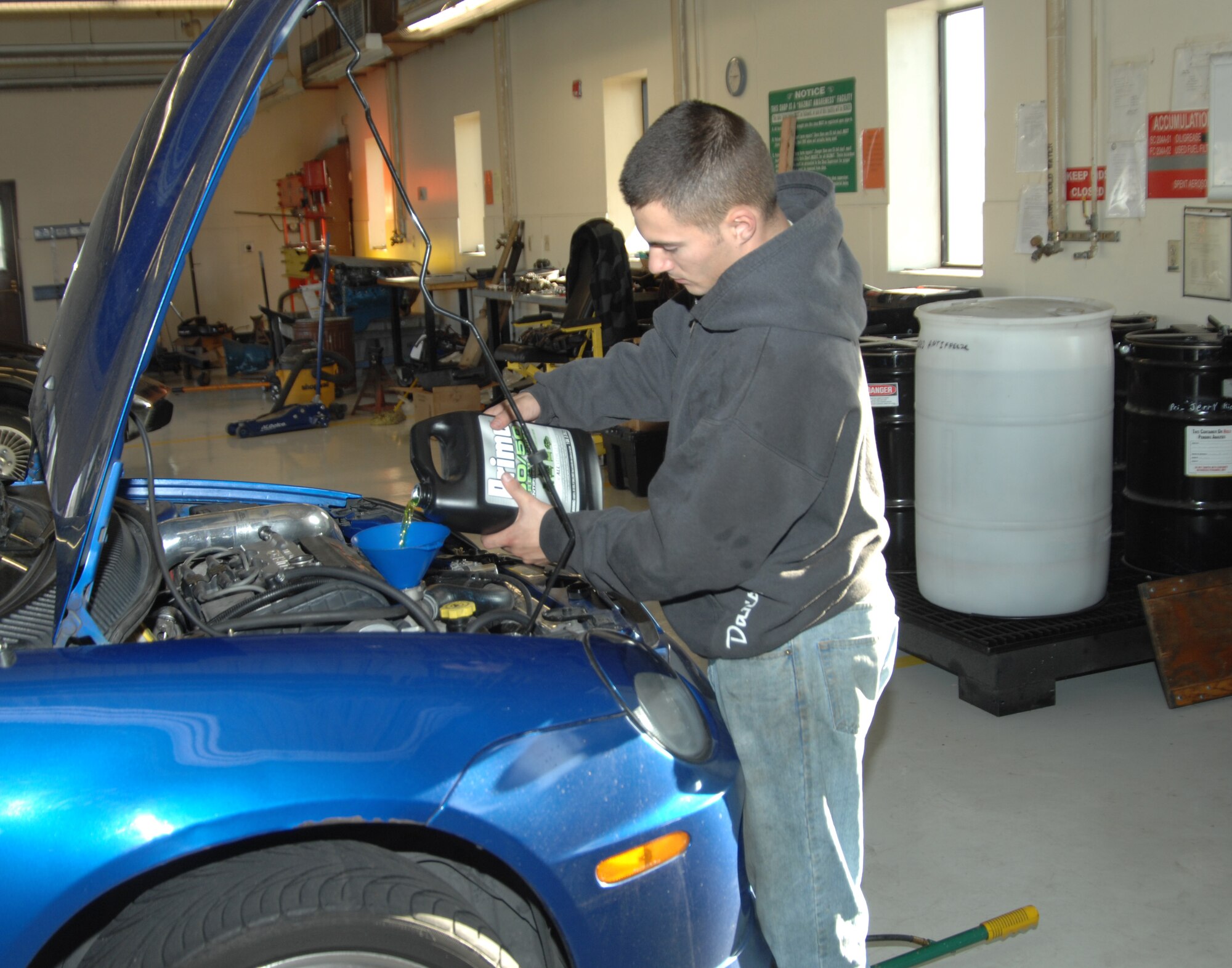 Airman 1st Class Gydeon Burgess, 391st Aircraft Maintenance Unit crew chief, pours anti-freeze into his 2008 Dodge Neon SRT-4 at the auto skills center in preparation for extreme winter weather Dec. 2, 2011, at Mountain Home Air Force Base, Idaho. The base auto skills center offers personnel a variety of winter vehicle safety checks and repairs. For more information, call the center at (208) 828-2295. (U.S. Air Force photo by Senior Airman Benjamin Sutton)