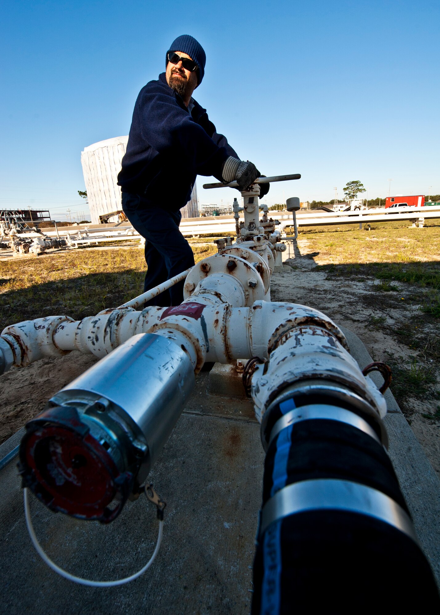 Mike White, a contractor with Maytag Aircraft Corp., turns the valve to begin offloading JP-8 from a tanker truck at Eglin Air Force Base, Fla.  Air Force fuel bulk storage areas are maintained exclusively by contractors.  (U.S. Air Force photo/Samuel King Jr.)