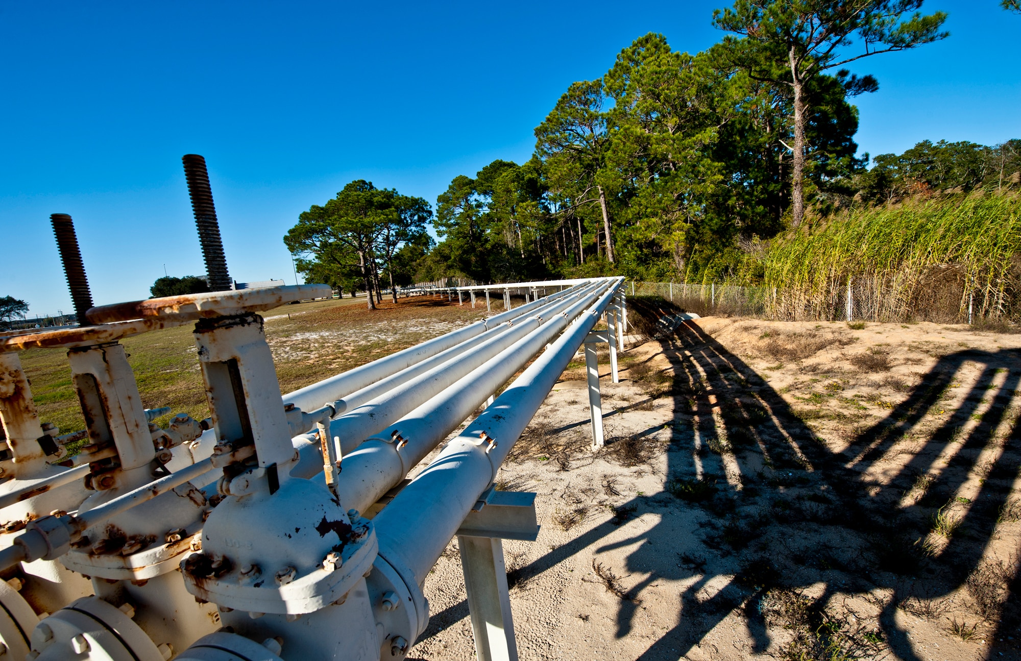 A pipeline makes its way from Weekly Bayou to one of three bulk storage tanks located on Eglin Air Force Base, Fla.  Air Force jet fuel can be delivered by barge or by tanker truck to the base.  (U.S. Air Force photo/Samuel King Jr.)