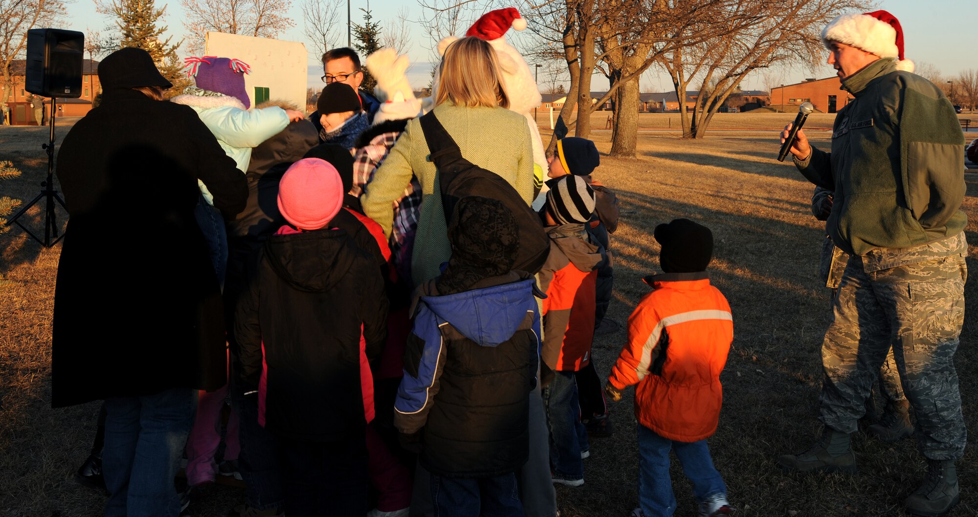 Col. Tim Bush, 319th Air Base Wing commander, asks children to help turn the switch on for the Christmas tree on Dec. 1 at Grand Forks Air Force Base, N.D.  Airmen, friends and family members attend the ceremony to kick-start the celebration of the holiday season.  (U.S. Air Force photo by Airman 1st Class Xavier Navarro)