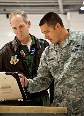 Tech. Sgt. Shawn Eubanks, a 33rd Maintenance Squadron maintainer, briefs Gen. Mike Hostage, the commander of Air Combat Command, about the new laptop used with the F-35 Lightning II, Nov. 30.  The computer is remotely connected to the joint strike fighter and talks directly to the aircraft to help find and diagnose potential problems.  (U.S. Air Force photo/Samuel King Jr.)