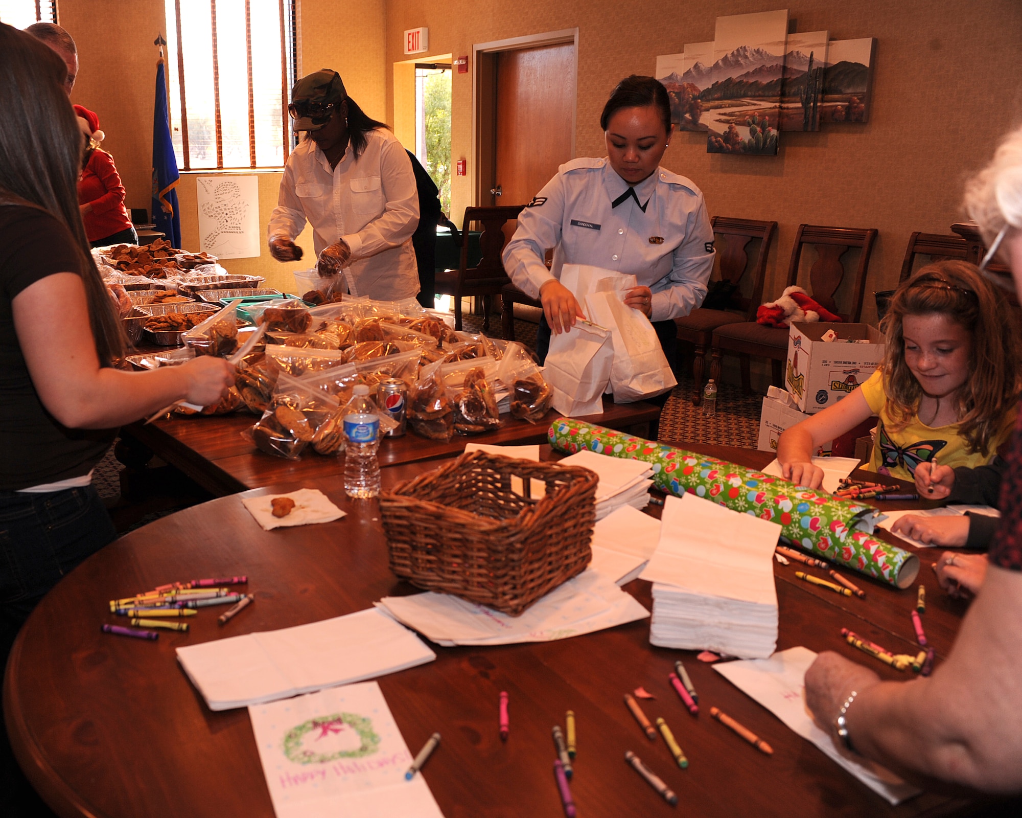 Davis-Monthan volunteers form an assembly line to bag cookies for the annual cookie crunch on Davis-Monthan Air Force Base, Ariz., Nov. 28, 2011. (U.S. Air Force photo by Airman 1st Class Christine Griffiths/Released)