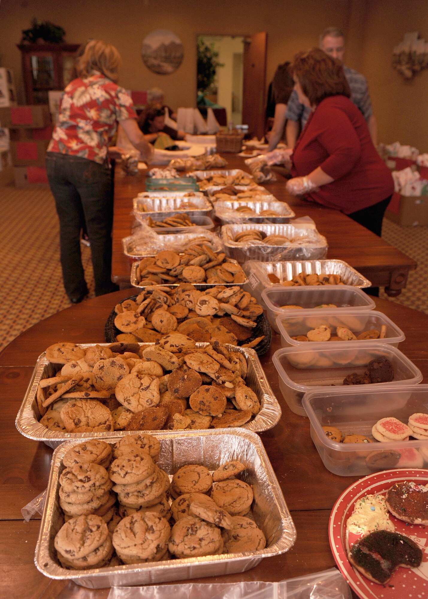 Cookies lie on the table to be gathered in bags during the annual cookie crunch on Davis-Monthan Air Force Base, Ariz., Nov. 28, 2011. The goal of the Davis-Monthan Officer Spouses Club is to deliver more than 2,000 bags of cookies to single Airman on and off base.  (U.S. Air Force photo by Airman 1st Class Christine Griffiths/Released) 