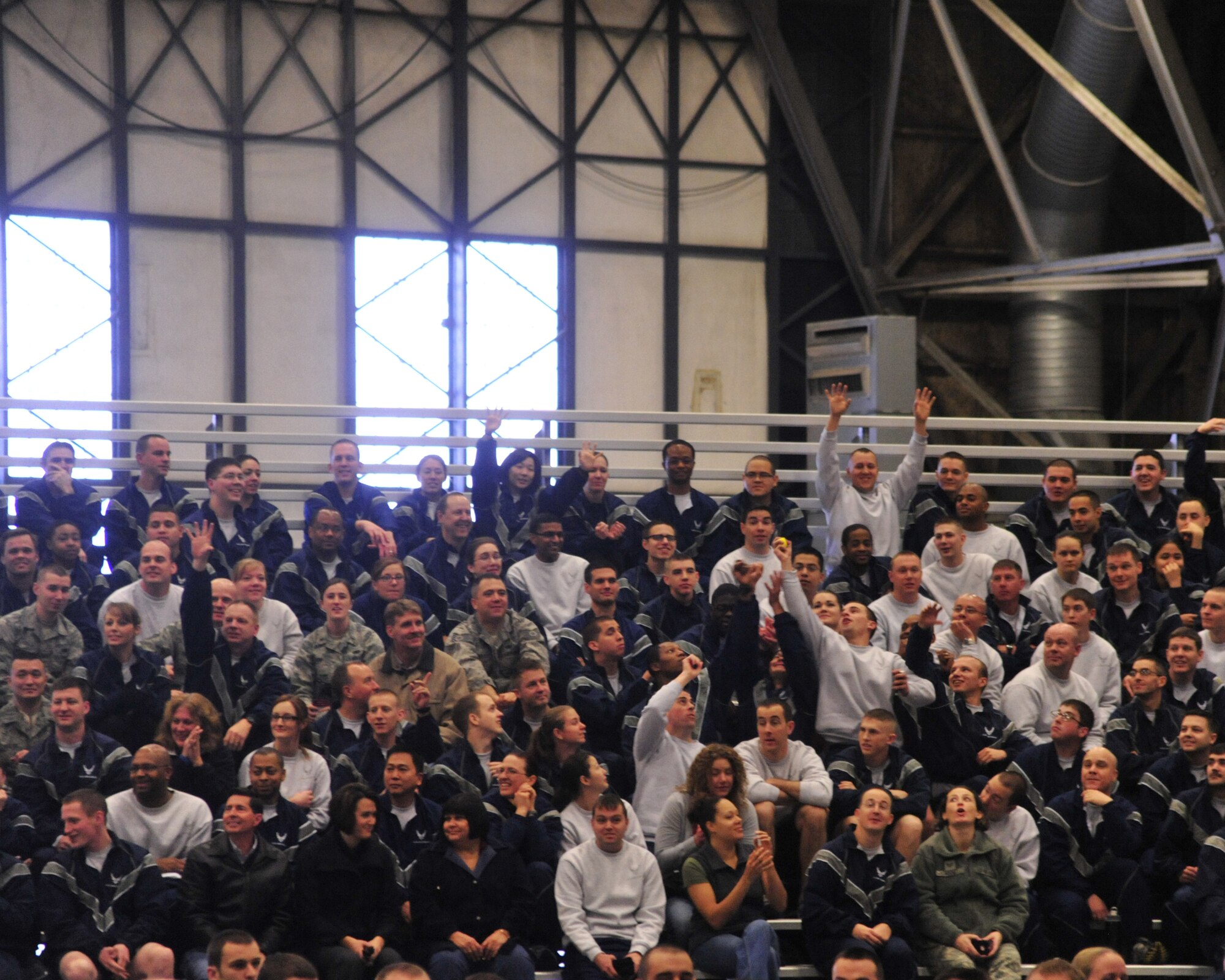 Members of the 62nd Airlift Wing and 627th Air Base Group receive tennis balls during the Wingman Day kick-off presentation Dec. 2, 2011, at Joint Base Lewis-McChord, Wash. The tennis balls represent the idea of "bouncing back" as part of resiliency. (U.S. Air Force photo/Staff Sgt. Frances Kriss)