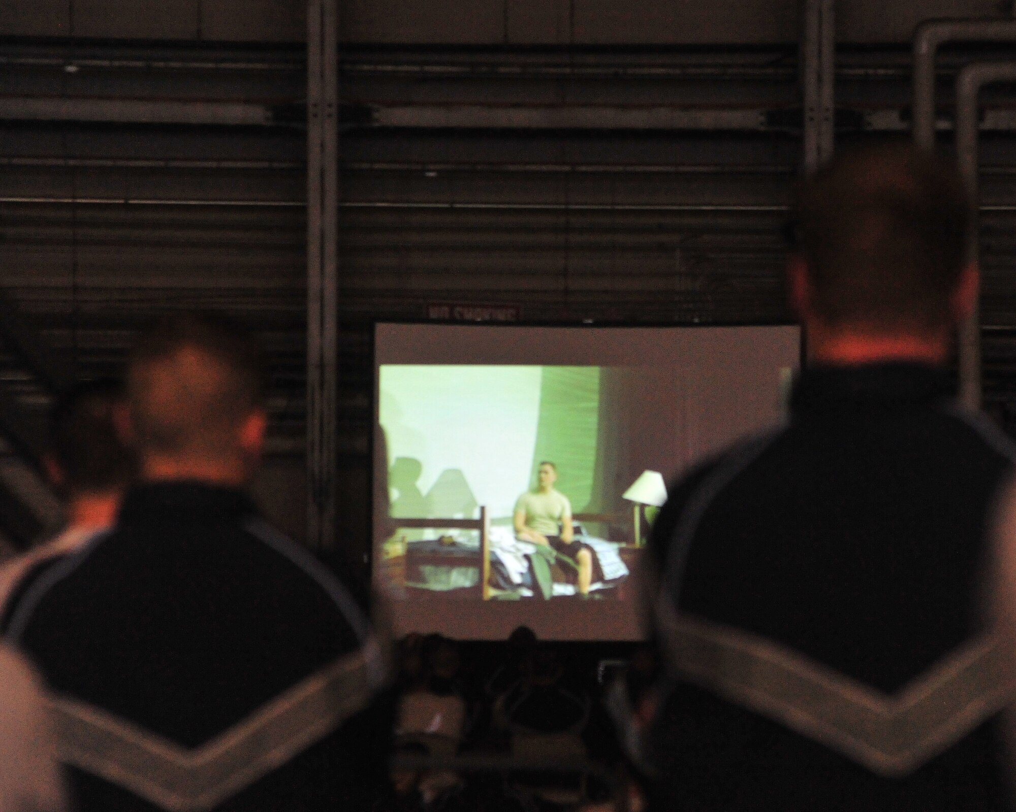 Members of the 62nd Airlift Wing and 627th Air Base Group watch a video depicting real-world problems that Airmen face Dec. 2, 2011, at Joint Base Lewis-McChord, Wash. The video was part of the Wingman Day kick-off presentation. (U.S. Air Force photo/Staff Sgt. Frances Kriss)