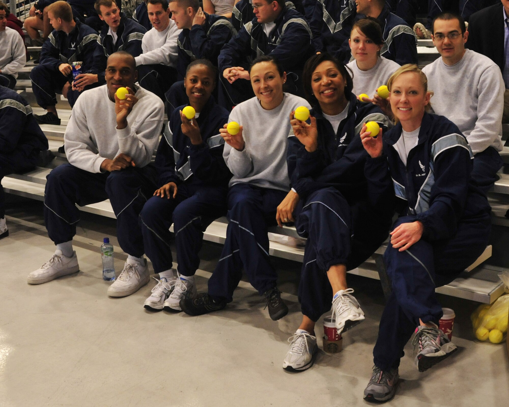 Team McChord Comprehensive Airmen Fitness master resilience trainers and assistants hold up tennis balls to represent "bouncing back" during Wingman Day Dec. 2, 2011, at Joint Base Lewis-McChord, Wash. The goal of the day is to build resilient Airmen and focus on unit health through the Resiliency Program. (U.S. Air Force photo/Staff Sgt. Frances Kriss)