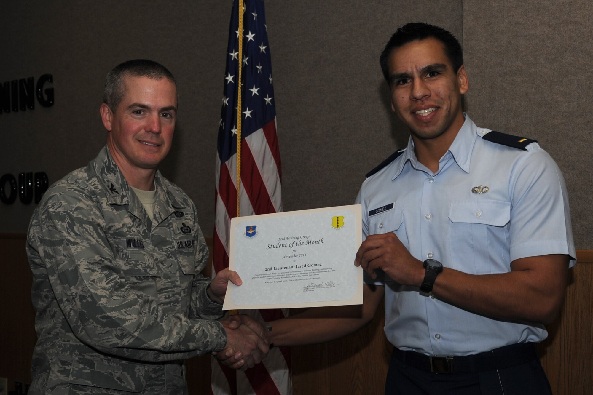 GOODFELLOW AIR FORCE BASE, Texas -- Col. JD Willis, 17th Training Group Commander, presents 2nd Lt. Jared Gomez with the 315th Training Squadron Officer Student of the Month award for November, Dec. 2. (U.S. Air Force photo/Staff Sgt. Laura R. McFarlane)