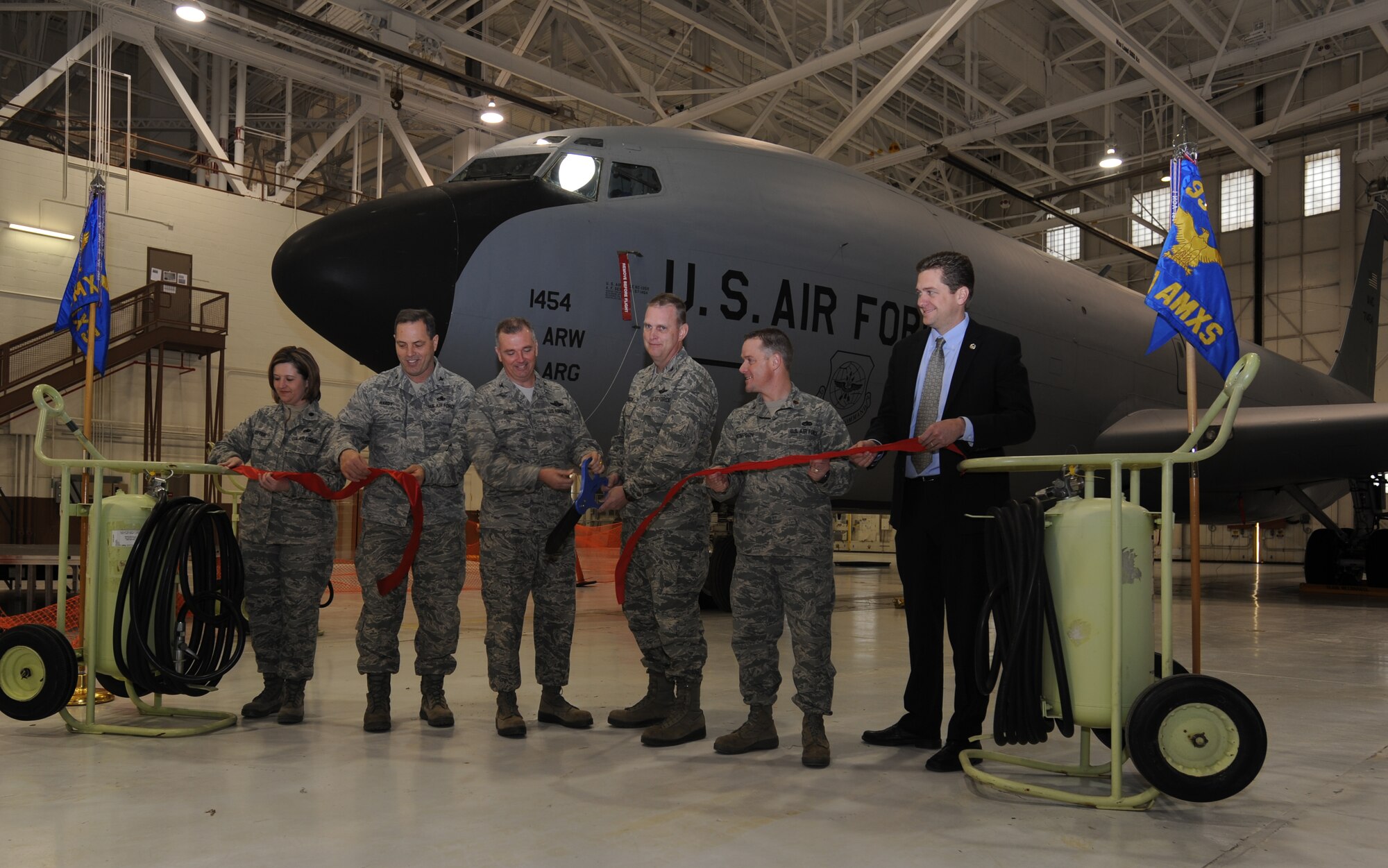 Col. Ricky Rupp, 22 ARW commander, and Col. William Mason, 931st ARG commander, cut the ribbon signifying the official opening of Hangar 1107 as the new Total Force Maintenance Facility that the 22 AMXS and the 931st AMXS will share. They were also joined by Col. Steven Hardy, 22 AMXG commander, Lt. Col. Mary Teeter, 22 AMXS commander, Justin Ladner, 931st AMXG honorary commander and Maj. Robert Thompson, 931st AMXS commander. (USAF photo by Tech Sgt. Mitch Fuqua)
