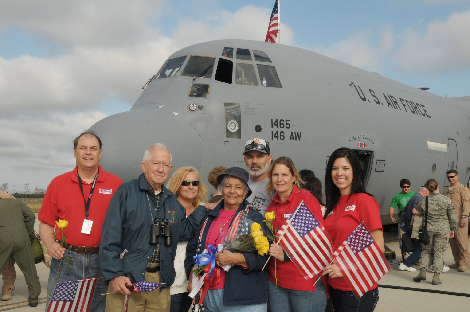 Members of the local Red Cross pose in front of a C 130 that brought home members of the 146th Airlift Wing that returned from an overseas deployment at Channel Islands Air National Guard Station on November 23, 2011. The Red Cross was on hand to welcome home airmen returning from a 90 day AEF rotation in Afghanistan. 