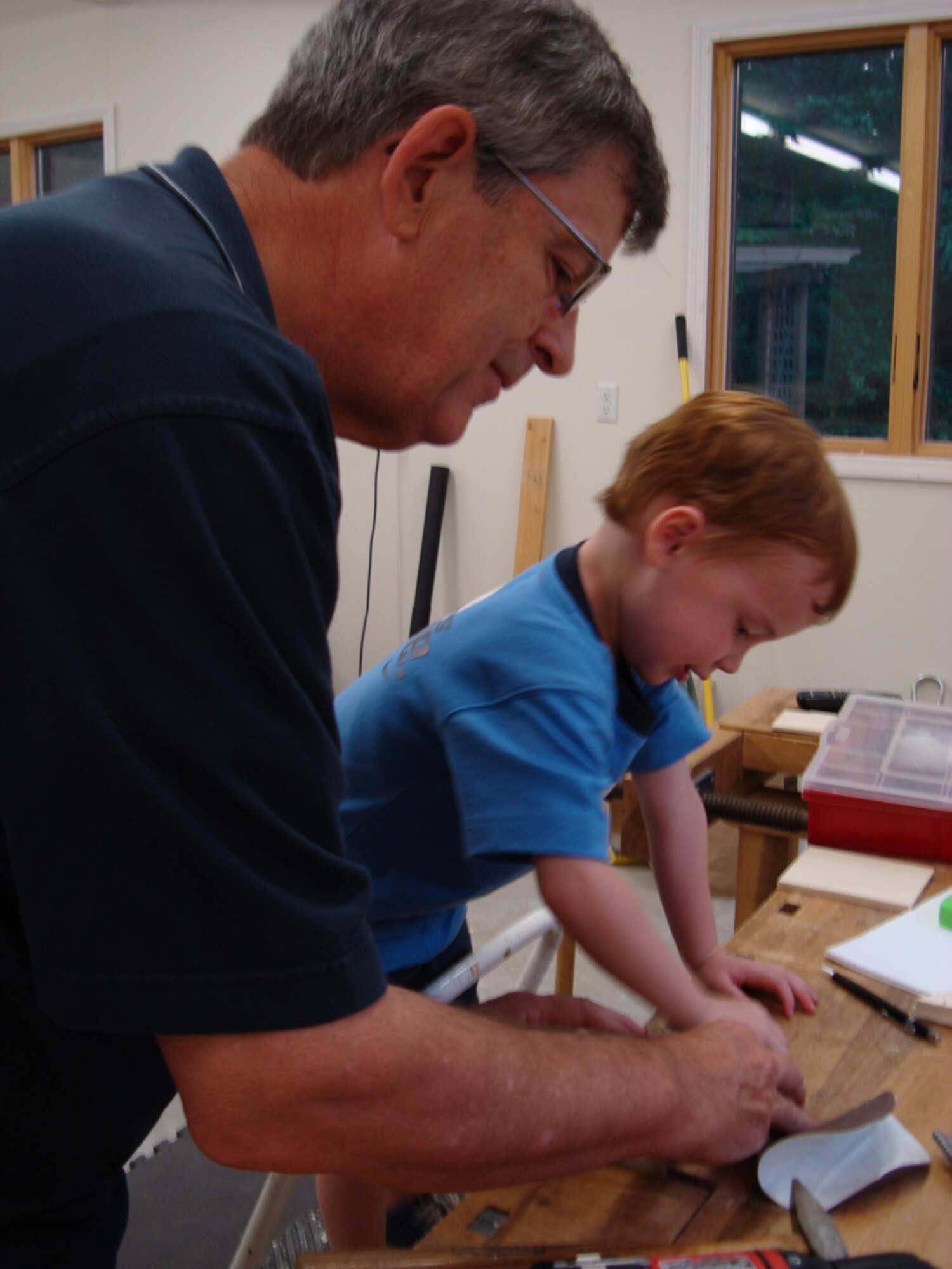 J.Y. Parker, AEDC director of Plans and Programs, enjoys working in his woodshop with his grandson, Tucker. (Photo provided) 