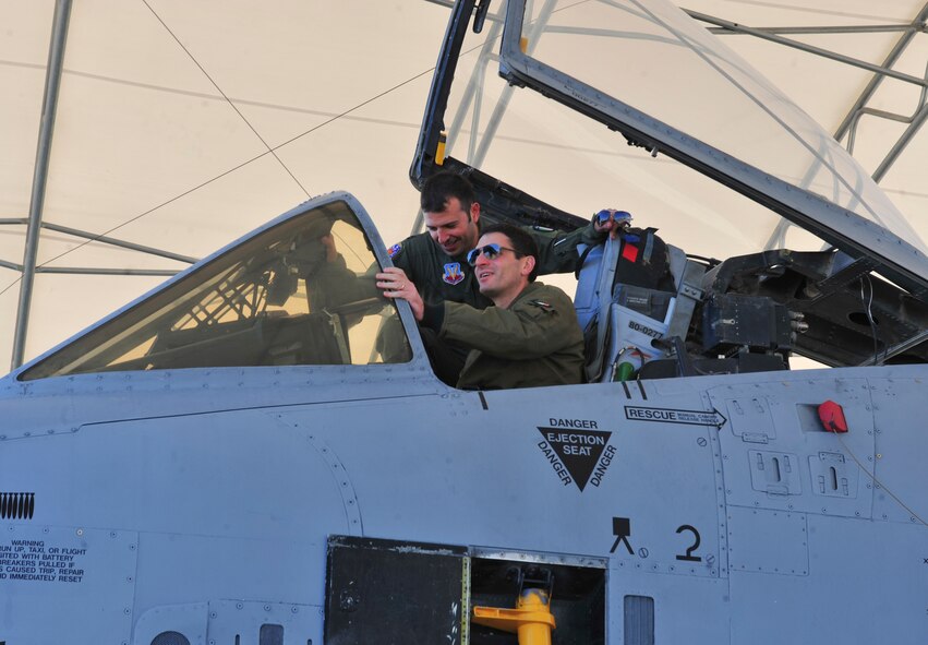 Italian air force Colonnello (Col.) Giorgio Foltran, Comando delle Forze da Combattimento chief of training, sits in the cockpit of an A-10C Thunderbolt II during a visit at Moody Air Force Base, Ga., Dec. 1, 2011. Capitano (Capt.) Maurizio De Guida, 74th Fighter Squadron A-10 exchange pilot, gave the tour and answered questions about the aircraft. (U.S. Air Force photo by Staff Sgt. Stephanie Mancha/Released)