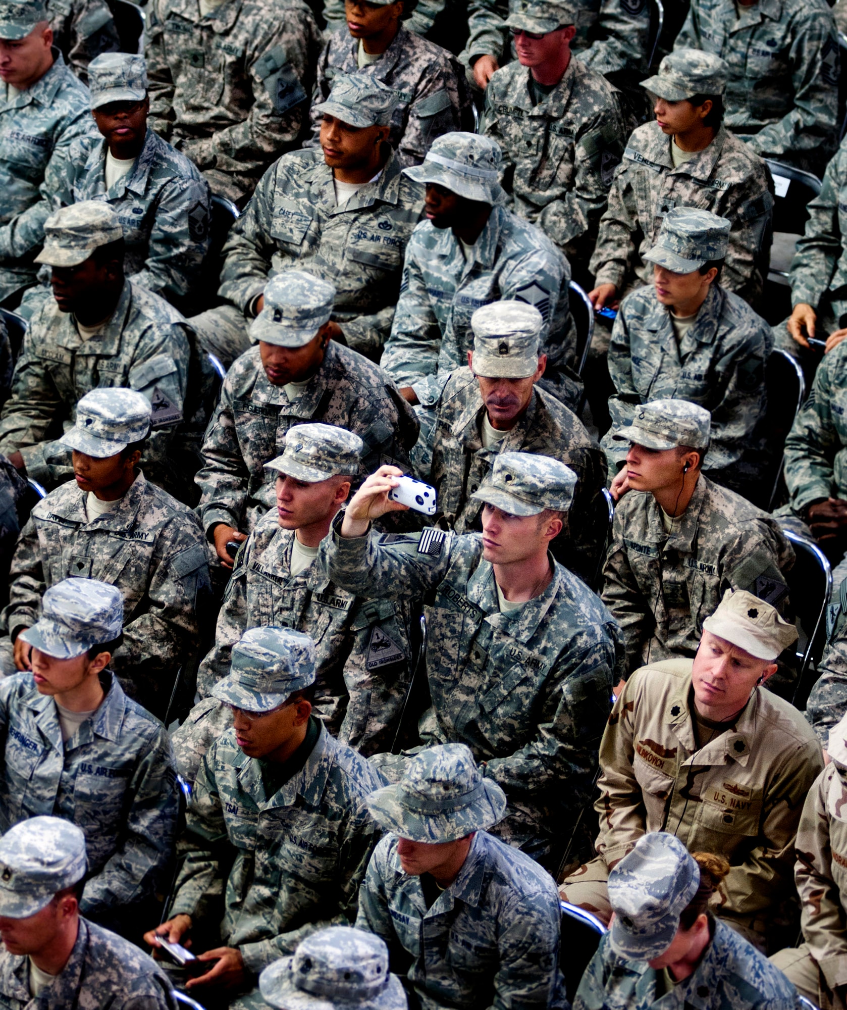 U.S. service members listen, record video, and take pictures during the  Commitment Day ceremony in the Al Faw Palace on Victory Base Complex, Iraq, on Dec. 1, 2011. The Government of Iraq hosted the ceremony to commemorate the sacrifices and accomplishments of U.S. and Iraqi service members. (U.S. Air Force photo/Master Sgt. Cecilio Ricardo)