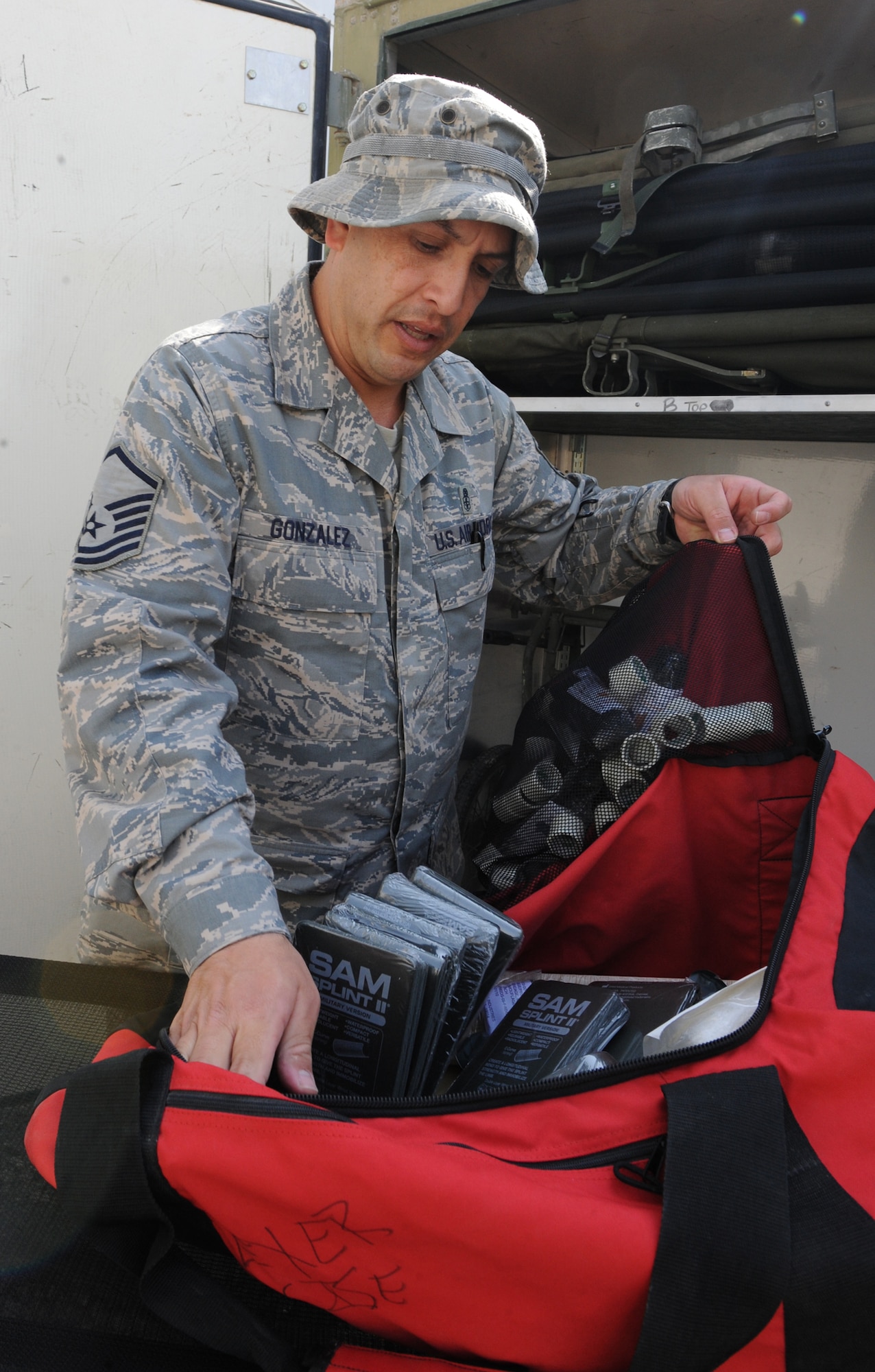 Master Sgt. Leonel Gonzalez opens up a medical kit in front of one of two medical containers at the 380th Expeditionary Wing Nov. 25, 2011. Each container, known as a CONEX in military jargon, is loaded with 20 litters, two litter carriers with wheels and medical kits with supplies similar to what troops will find in their improvised first aid kits. Deployed medical personnel have a launched a new program that will help ensure quick access to medical supplies in the event of an emergency or mass casualty event at the 380th Air Expeditionary Wing. Gonzalez is the NCO in charge of clinical operations for the 380th Expeditionary Medical Group. He is deployed from the 779th Medical Group at Joint Base Andrews, Md., and is from Fredericksburg, Va. (U.S. Air Force photo/Master Sgt. Chance Babin)
