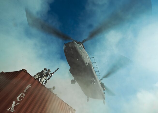 U.S. Air Force Airmen, 820th RED HORSE Squadron airborne flight, prepare a connex box for a sling-load as a CH-47 Chinook, Army National Guard, Stockton, CA, approaches during a peacetime operation Nov. 9, 2011, at Alamo, Nev. The sling load training and air assault certification of 820th RHS airborne flight Airmen proved crucial in the success of the quick response operation. (U.S. Air Force photo by Staff Sgt. Christopher Hubenthal/Released)