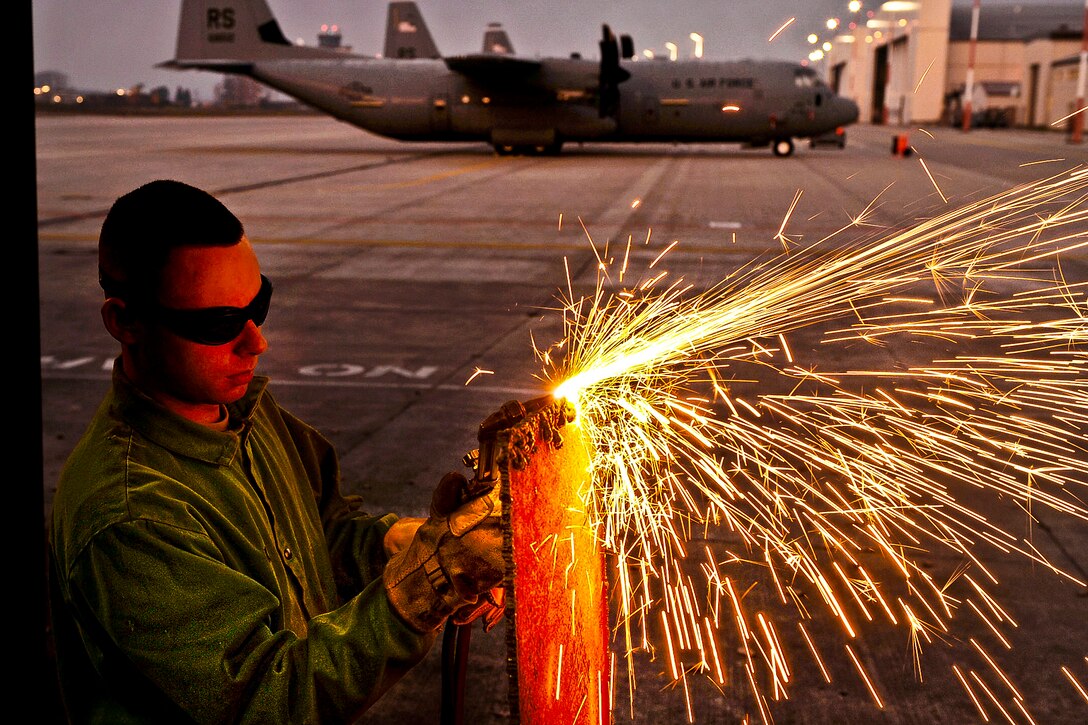 U.S. Air Force Staff Sgt. Daniel Kay cuts diamond-plate steel with an oxyacetylene torch on Ramstein Air Base, Germany, Nov. 22, 2011. Kay is an aircraft metals technology craftsman assigned to the 86th Maintenance Squadron.