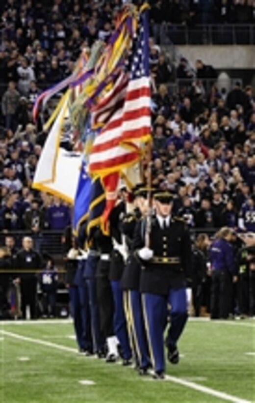 U.S. Army soldiers with the Continental Color Guard, 3rd U.S. Infantry Regiment (The Old Guard) march on to the football field during a Joint Armed Forces Color Guard presentation at the Baltimore Ravens vs. San Francisco 49ers Thanksgiving football game in Baltimore, Md., on Nov. 24, 2011.  