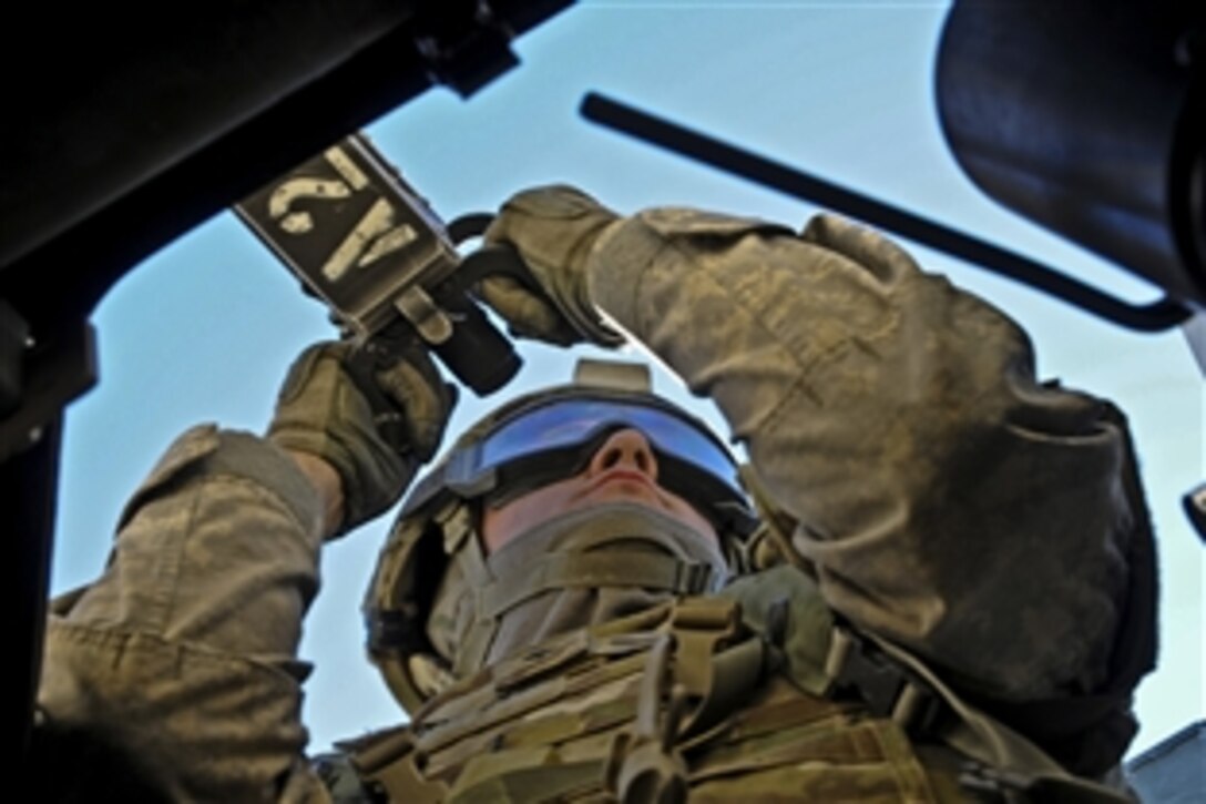 Army Spc. Michael L. Noel scans his sector from inside a gunner's turret during training at the National Training Center on Fort Irwin, Calif., Nov. 30, 2011. Noel is a personal security detail soldier assinged to the Infantry Brigade Combat Team. His unit is preparing to deploy to Afghanistan in support of Operation Enduring Freedom.