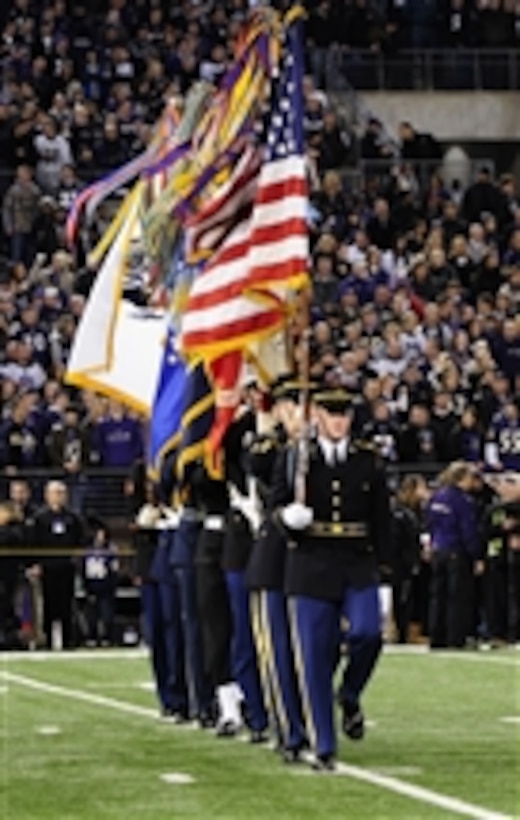 U.S. Army soldiers with the Continental Color Guard, 3rd U.S. Infantry Regiment (The Old Guard) march on to the football field during a Joint Armed Forces Color Guard presentation at the Baltimore Ravens vs. San Francisco 49ers Thanksgiving football game in Baltimore, Md., on Nov. 24, 2011.  