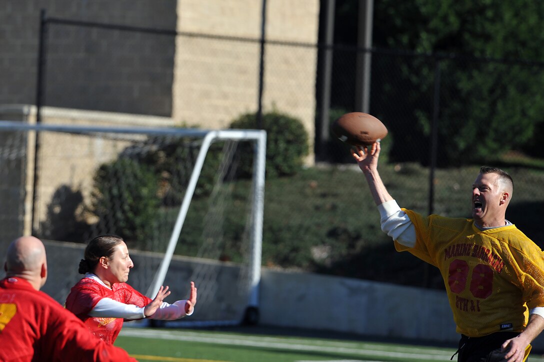 Maj. Scott Clippinger, Team CO starting quarterback, throws the ball during the team’s first possession of the 2011 Oyster Bowl at Marine Barracks Washington Dec. 2. The Oyster Bowl is a yearly flag-football faceoff between the Barracks commanding officer’s team, yellow, and the executive officer’s team, red. The XO’s team shut out the CO’s team with 18 points.