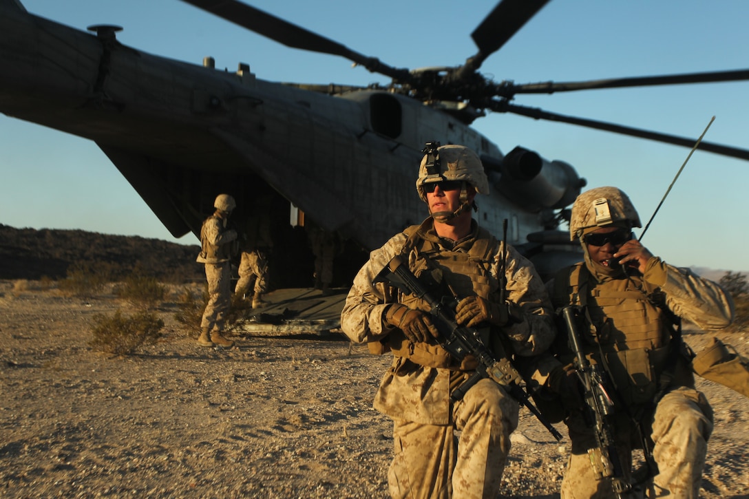 Marines with Weapons Company, 1st Battalion, 8th Marine Regiment step off the CH-53E Super Stallion after successfully completing their TRAP exercise Dec. 3, 2011.